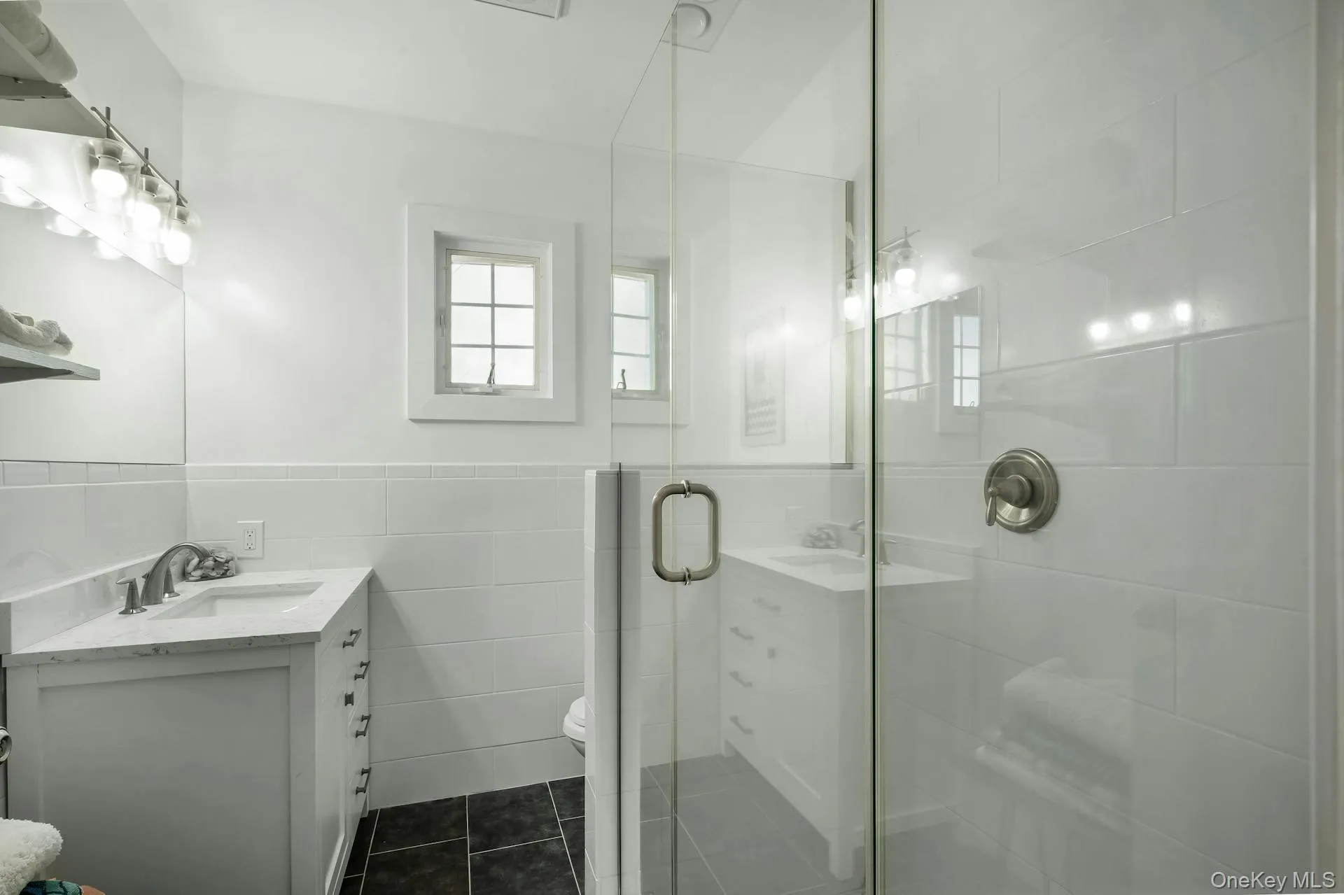 Glass-enclosed shower with white subway tile surround and brushed nickel fixtures Glass-enclosed shower with white subway tile surround and brushed nickel fixtures