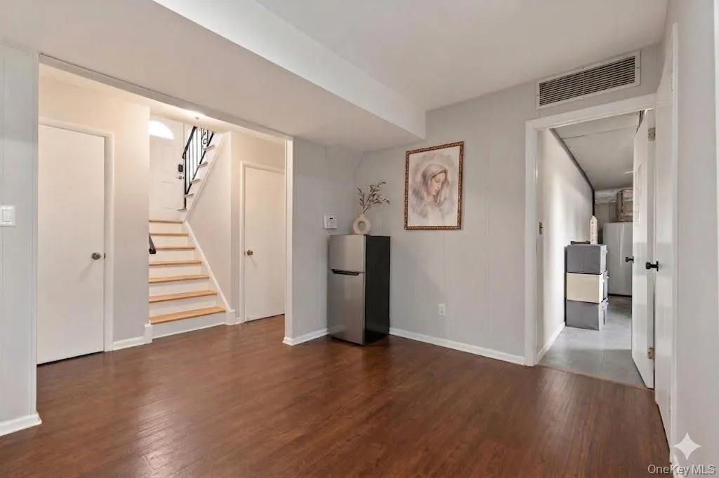 Hardwood-finish flooring throughout, complemented by light gray wall paneling Hardwood-finish flooring throughout, complemented by light gray wall paneling