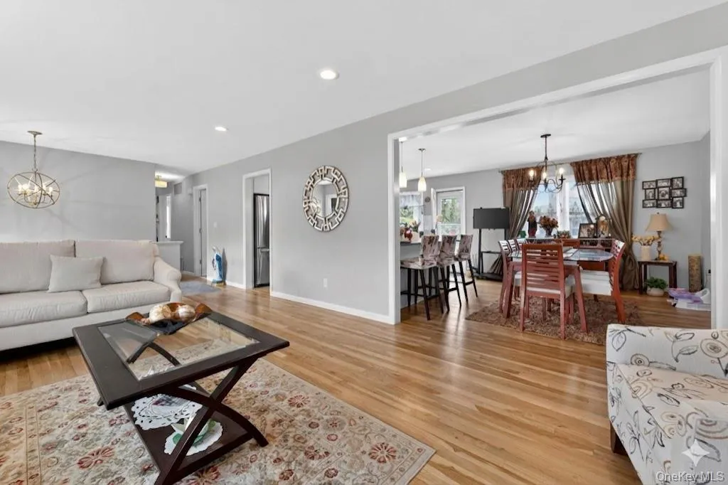 Hardwood flooring extends throughout this open-concept living and dining area Hardwood flooring extends throughout this open-concept living and dining area