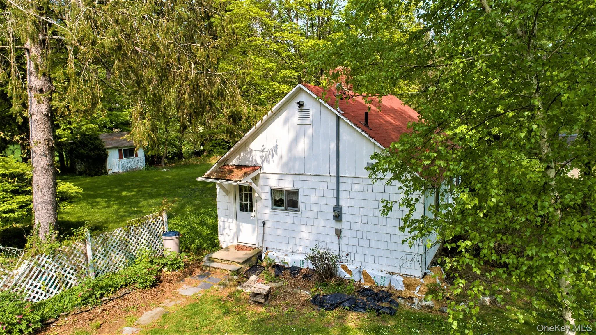 View of side of home with a lawn and entry steps View of side of home with a lawn and entry steps