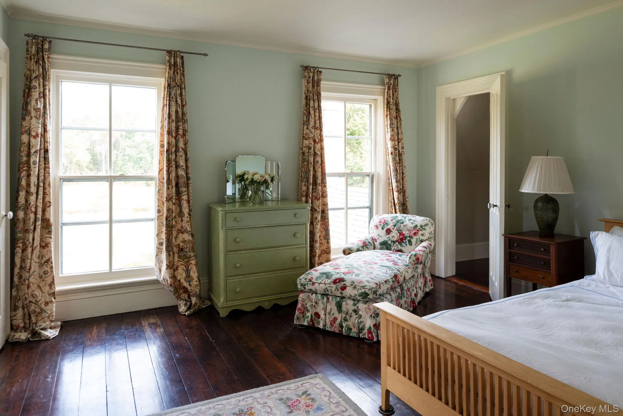 Bedroom featuring dark wood finished floors and ornamental molding Bedroom featuring dark wood finished floors and ornamental molding