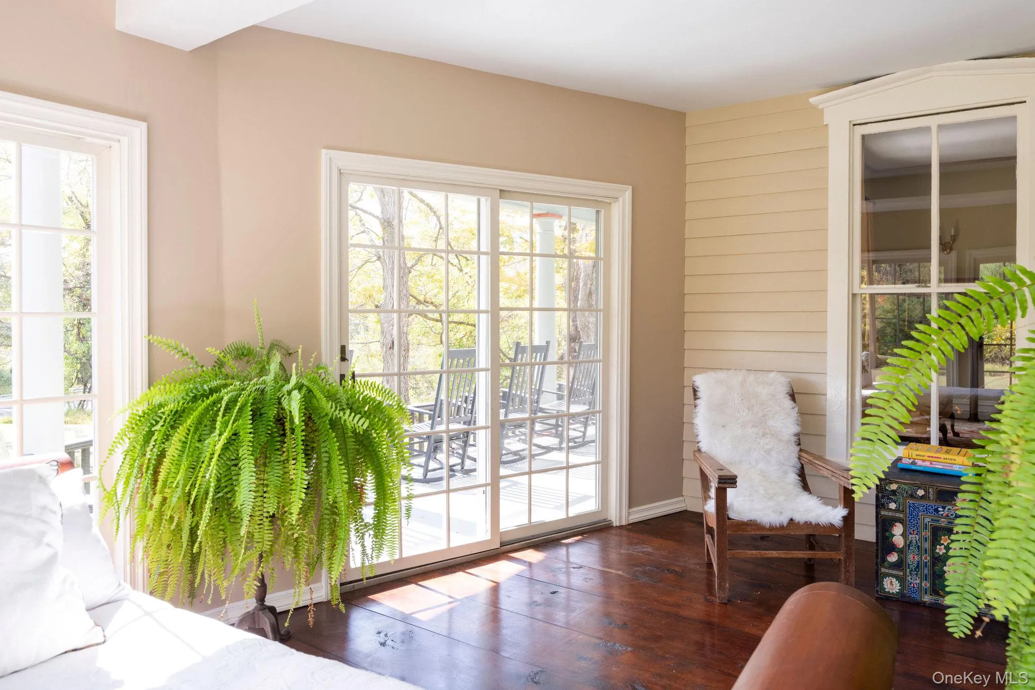 Doorway to outside with hardwood / wood-style flooring and baseboards Doorway to outside with hardwood / wood-style flooring and baseboards