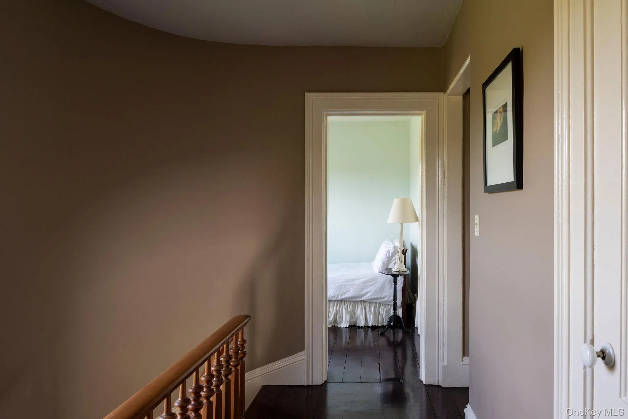 Corridor with baseboards and dark wood-style floors Corridor with baseboards and dark wood-style floors