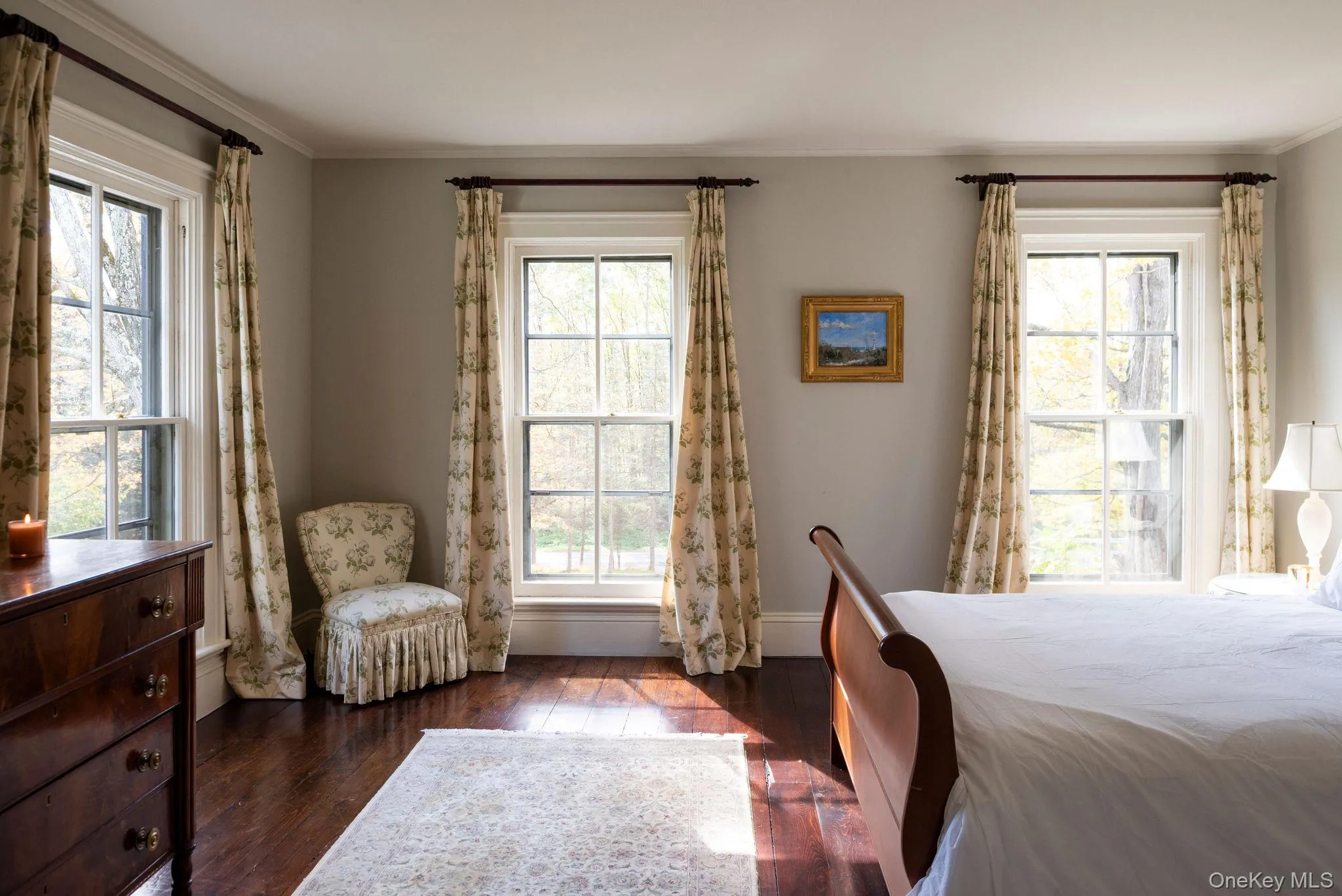 Bedroom featuring dark wood finished floors and crown molding Bedroom featuring dark wood finished floors and crown molding