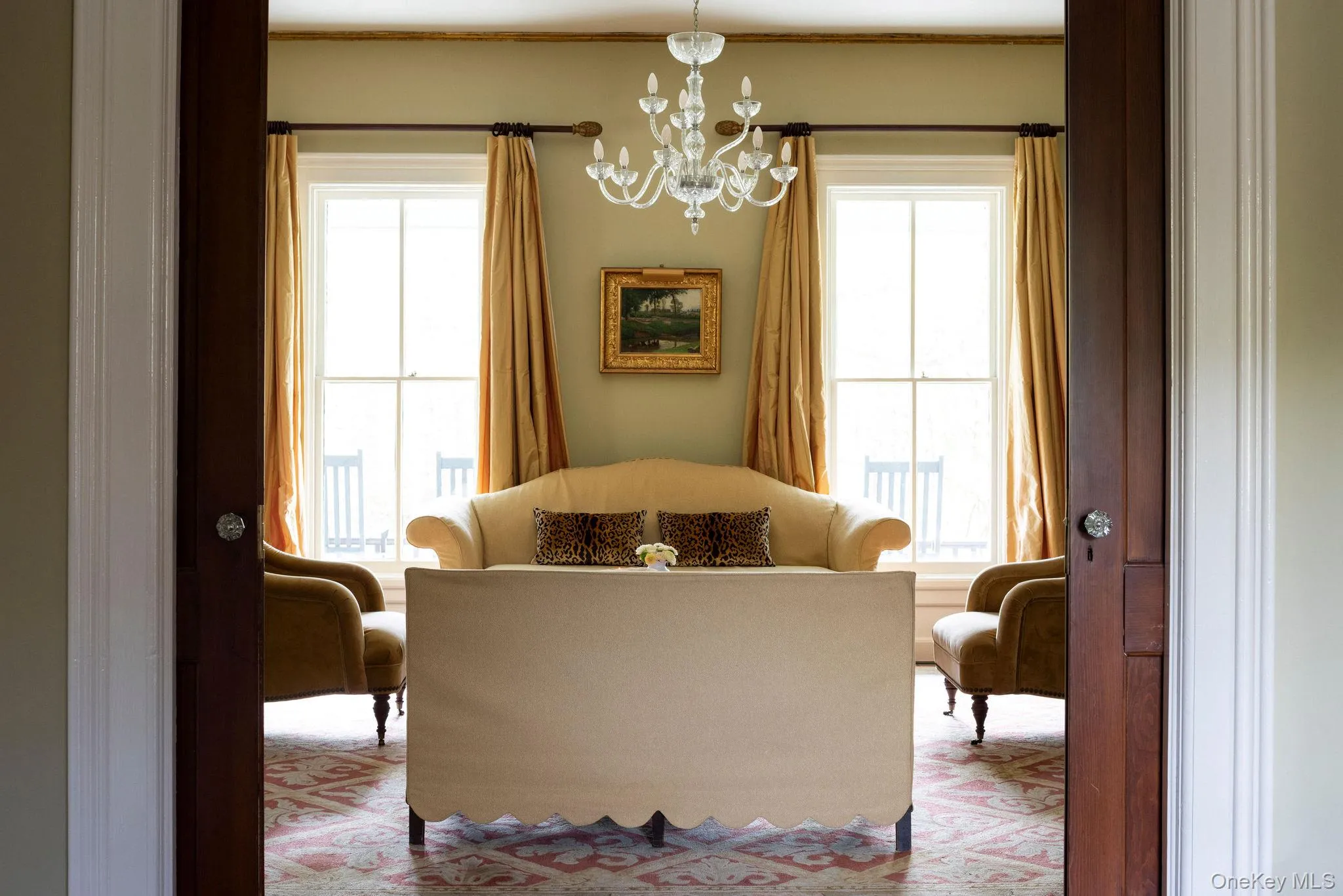 Sitting room featuring a chandelier and plenty of natural light Sitting room featuring a chandelier and plenty of natural light