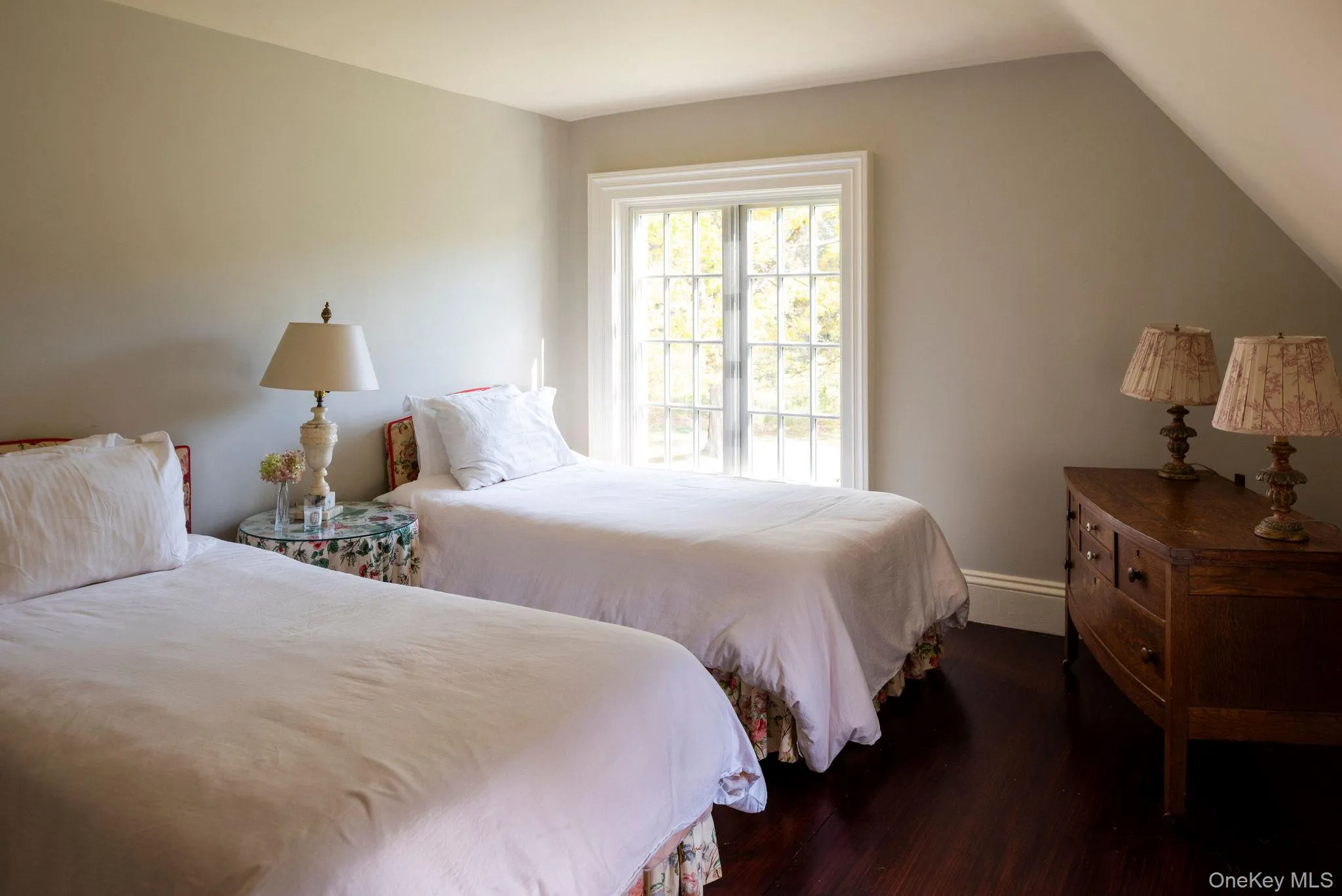 Bedroom featuring wood finished floors and vaulted ceiling Bedroom featuring wood finished floors and vaulted ceiling