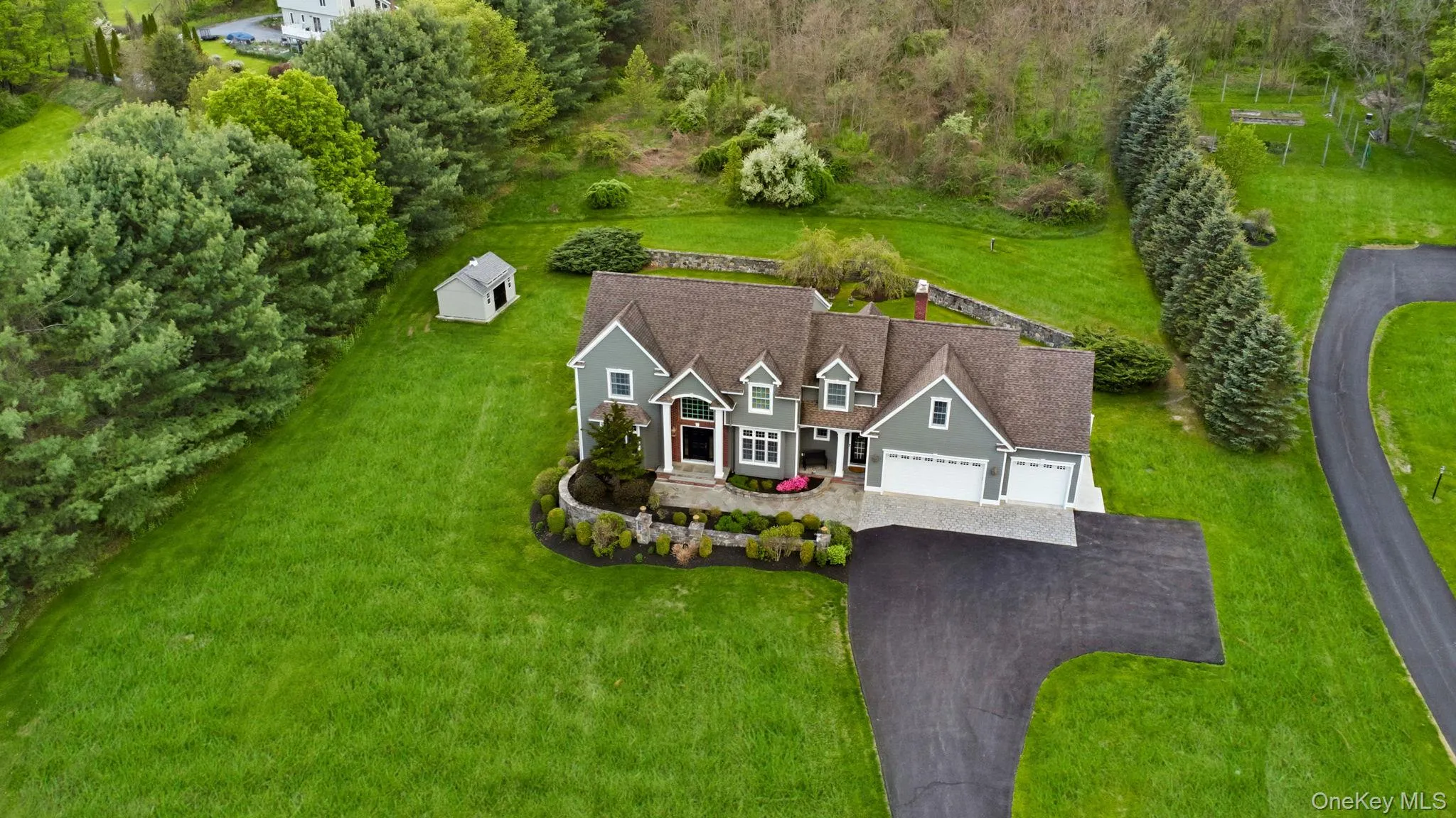 Contemporary residence featuring a multi-gabled roofline and mature trees for privacy Contemporary residence featuring a multi-gabled roofline and mature trees for privacy