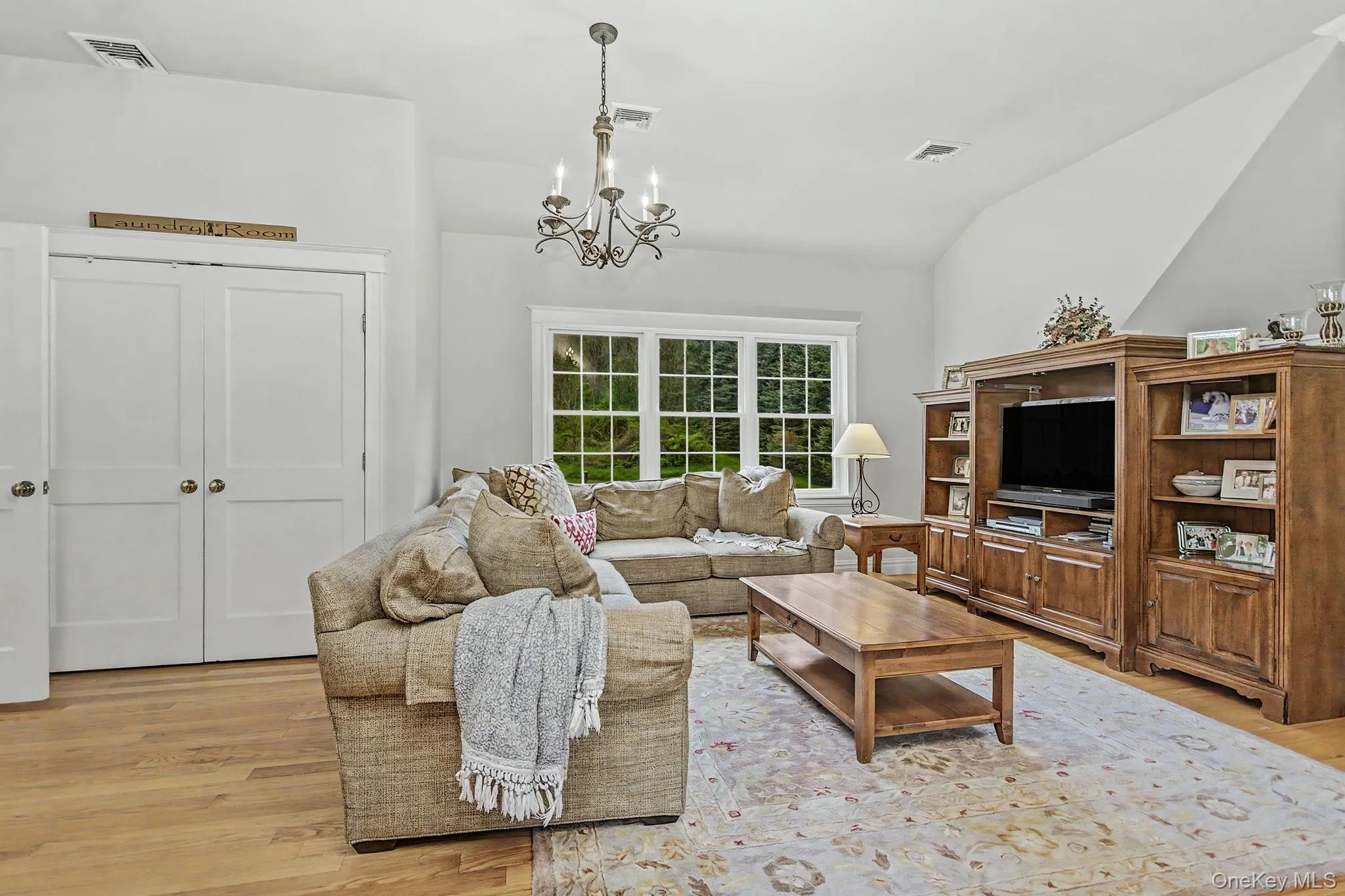 Vaulted ceiling with a chandelier, HWF, Laundry in closet... Vaulted ceiling with a chandelier, HWF, Laundry in closet...