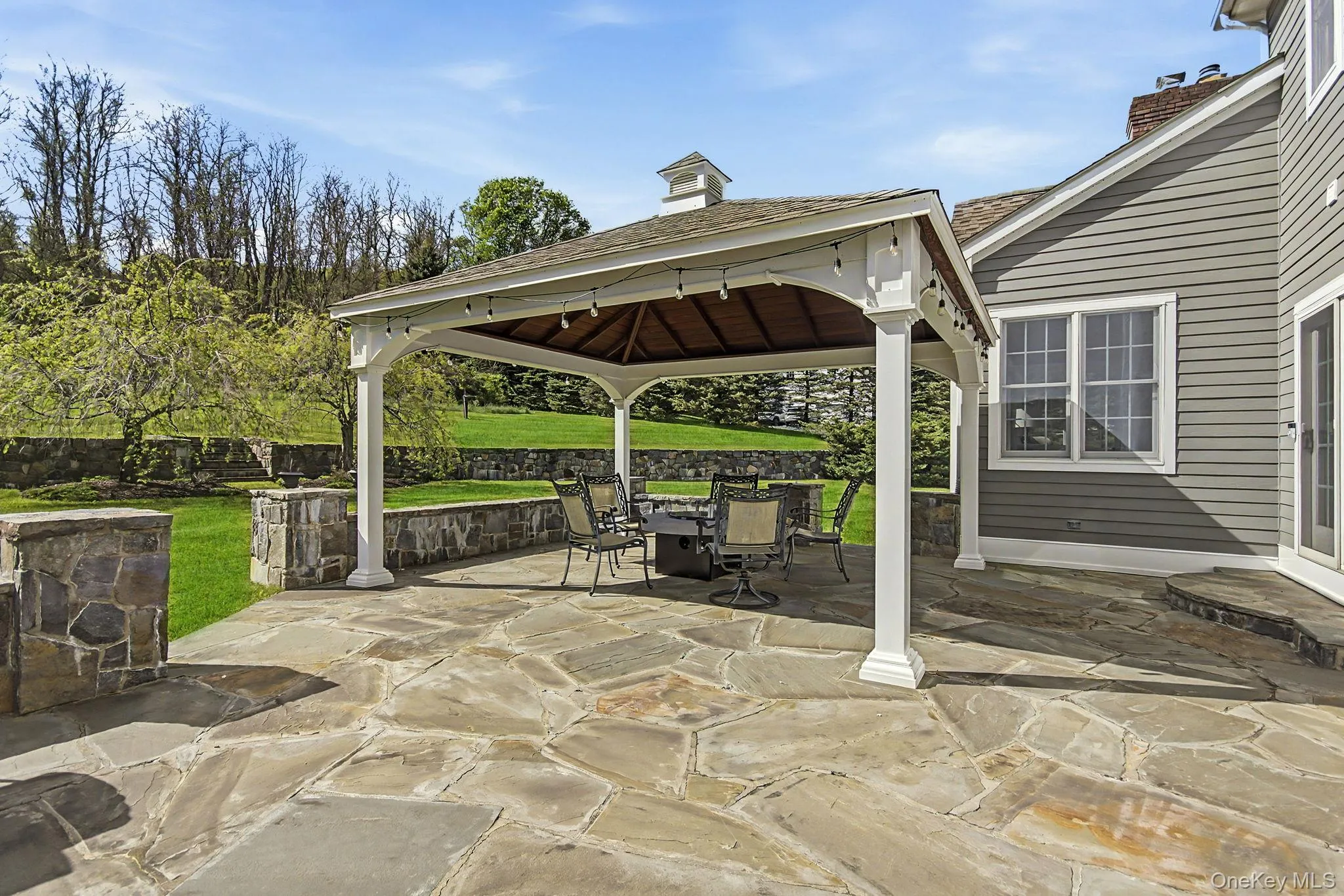Custom pavilion and expansive flagstone patio and stone walls. Custom pavilion and expansive flagstone patio and stone walls.