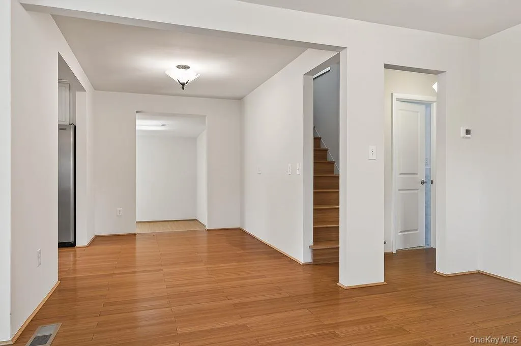 Spacious battler's area featuring wood-finish flooring, bright tone walls, and recessed lighting Spacious battler's area featuring wood-finish flooring, bright tone walls, and recessed lighting