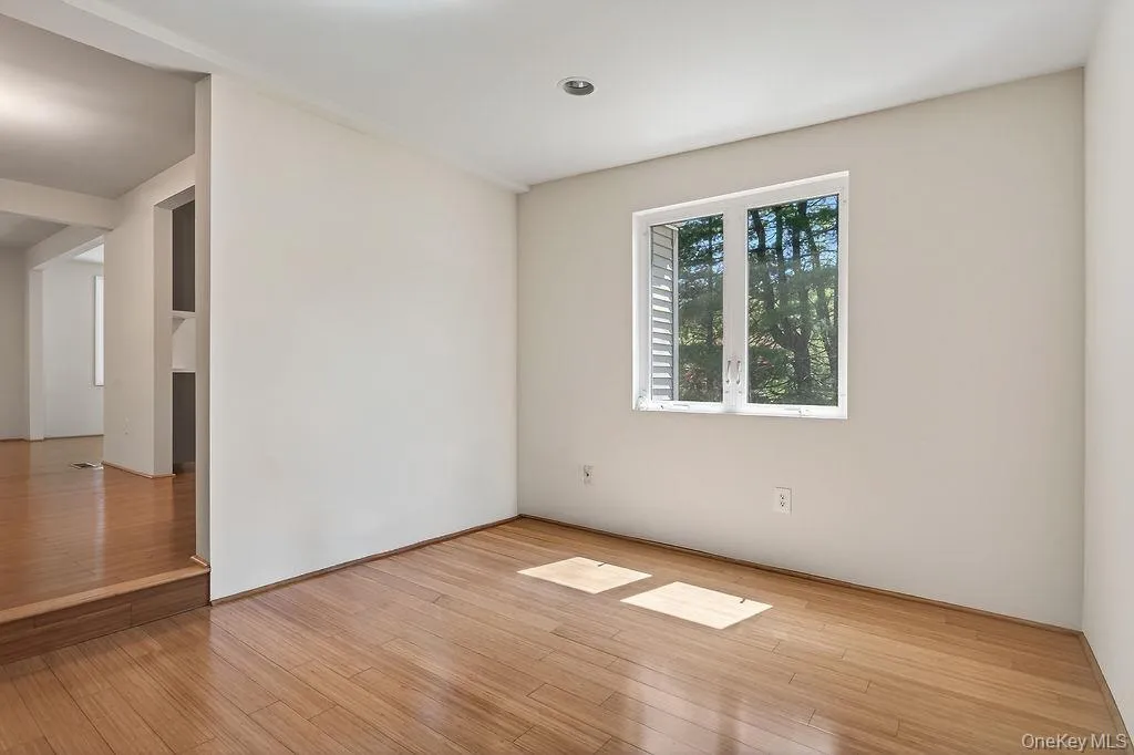 Hardwood-finish flooring extending into an adjacent space Hardwood-finish flooring extending into an adjacent space