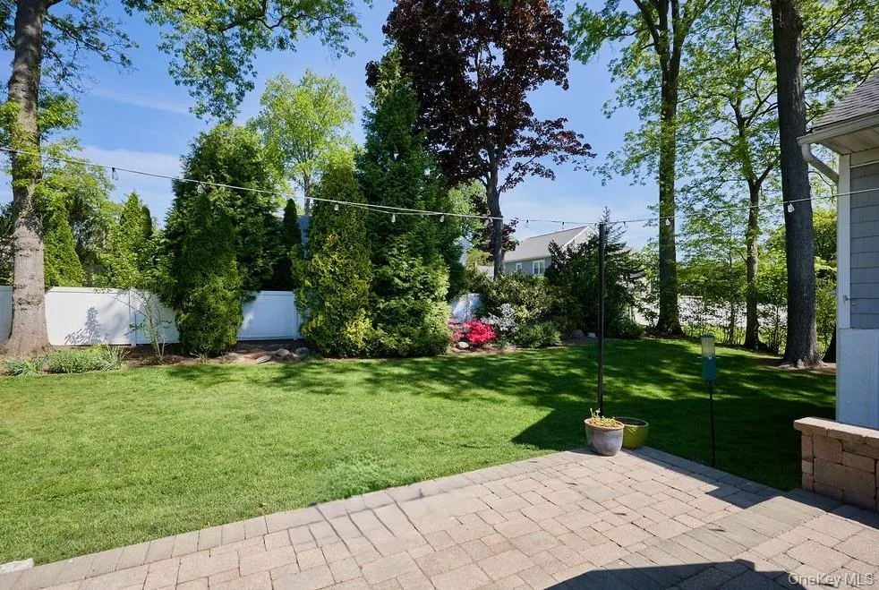 Expansive backyard featuring manicured lawn, and mature trees Expansive backyard featuring manicured lawn, and mature trees
