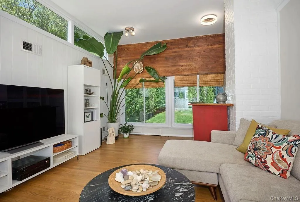 Family room with a wall of windows and view to the back yard Family room with a wall of windows and view to the back yard