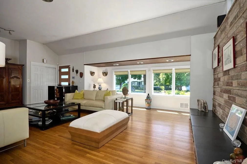 Spacious living area featuring hardwood flooring Spacious living area featuring hardwood flooring