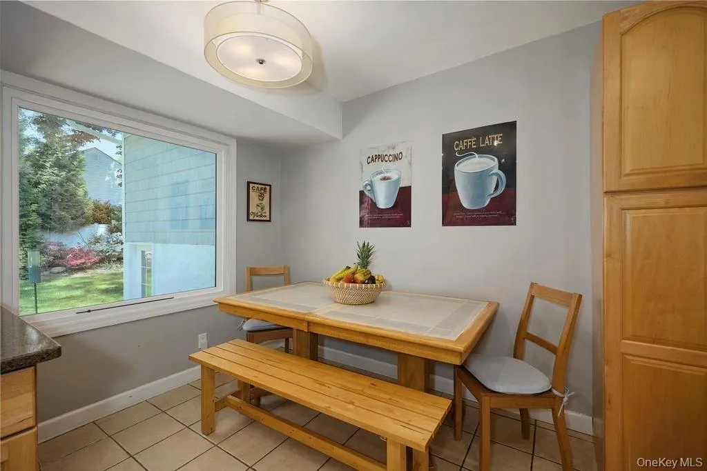 Kitchen dining area featuring a large window Kitchen dining area featuring a large window