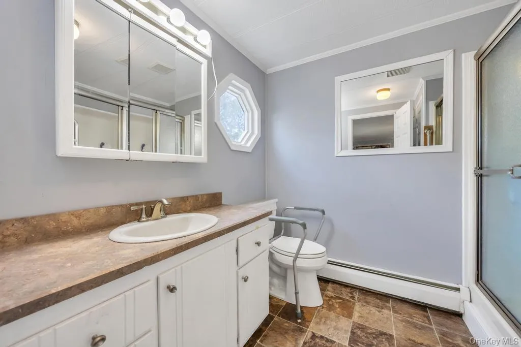 Bathroom vanity with a white cabinet, integrated sink, and a brown patterned countertop Bathroom vanity with a white cabinet, integrated sink, and a brown patterned countertop