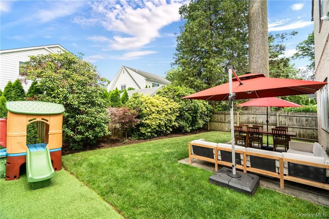 The yard includes a section with artificial turf for playing The yard includes a section with artificial turf for playing