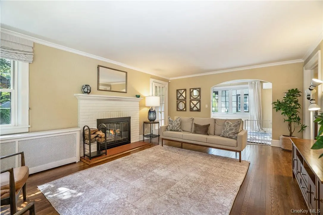Large, sunny living room with wood burning fireplace Large, sunny living room with wood burning fireplace