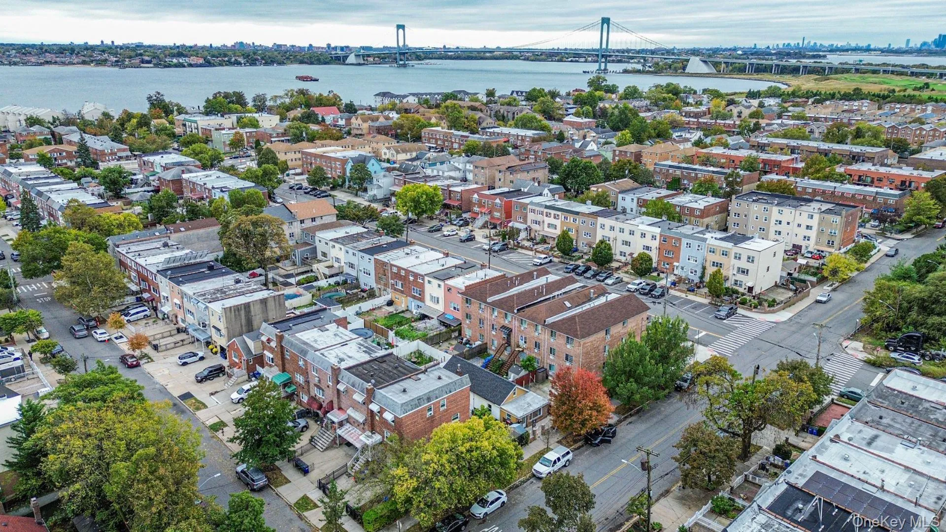 View of urban area with a notable bridge and a large body of water View of urban area with a notable bridge and a large body of water