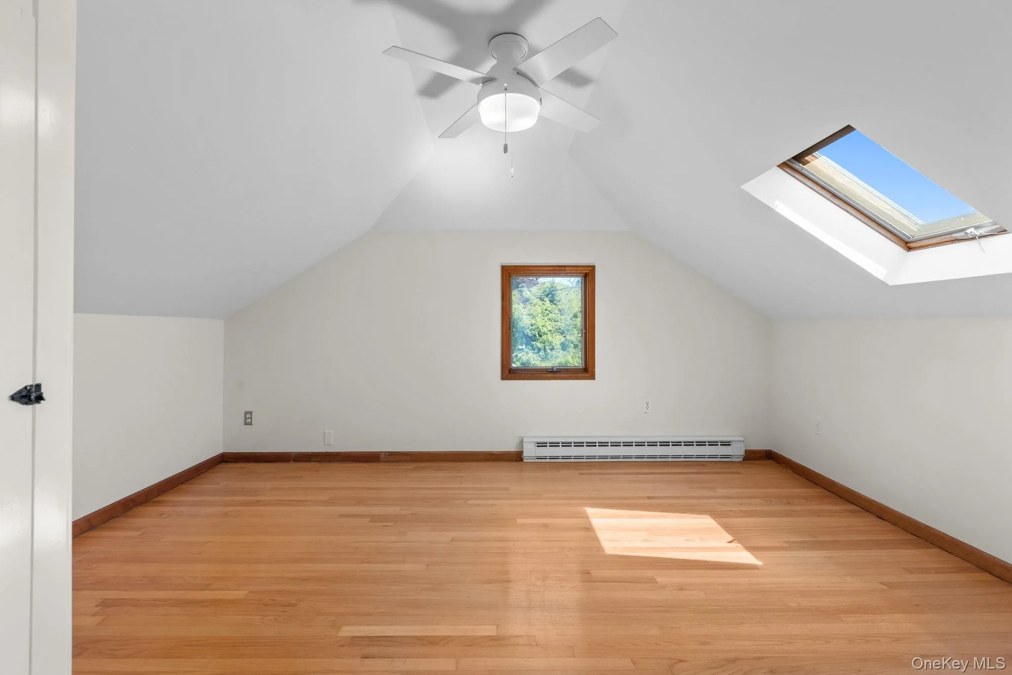 Skylight and hardwood floor highlight the upstairs den/family room space Skylight and hardwood floor highlight the upstairs den/family room space
