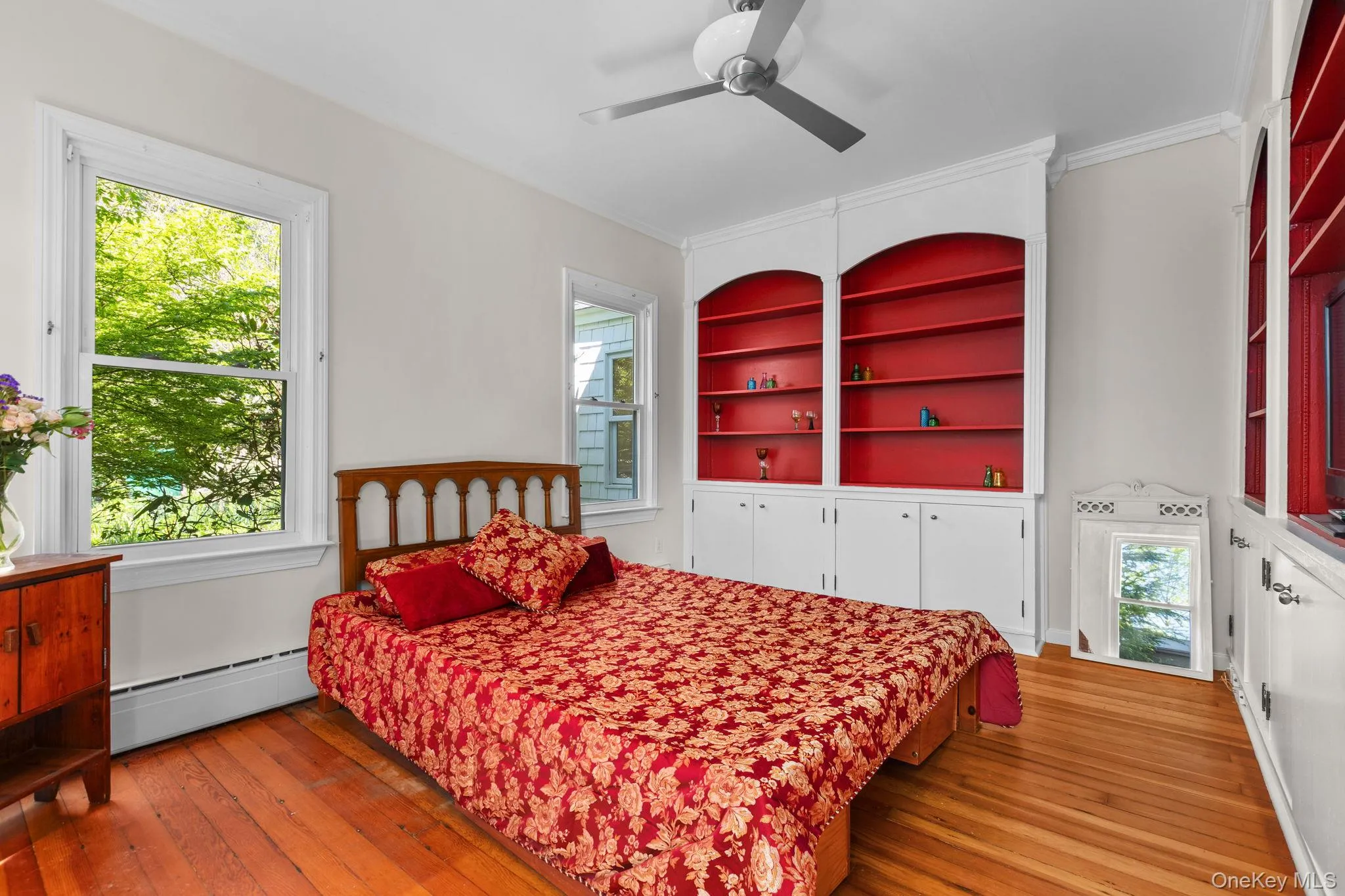 The main level bedroom is across from the bath,, hardwood floors and builtin shelving and cabinets. Its private location makes it a ideal primary bedroom or guest room The main level bedroom is across from the bath,, hardwood floors and builtin shelving and cabinets. Its private location makes it a ideal primary bedroom or guest room
