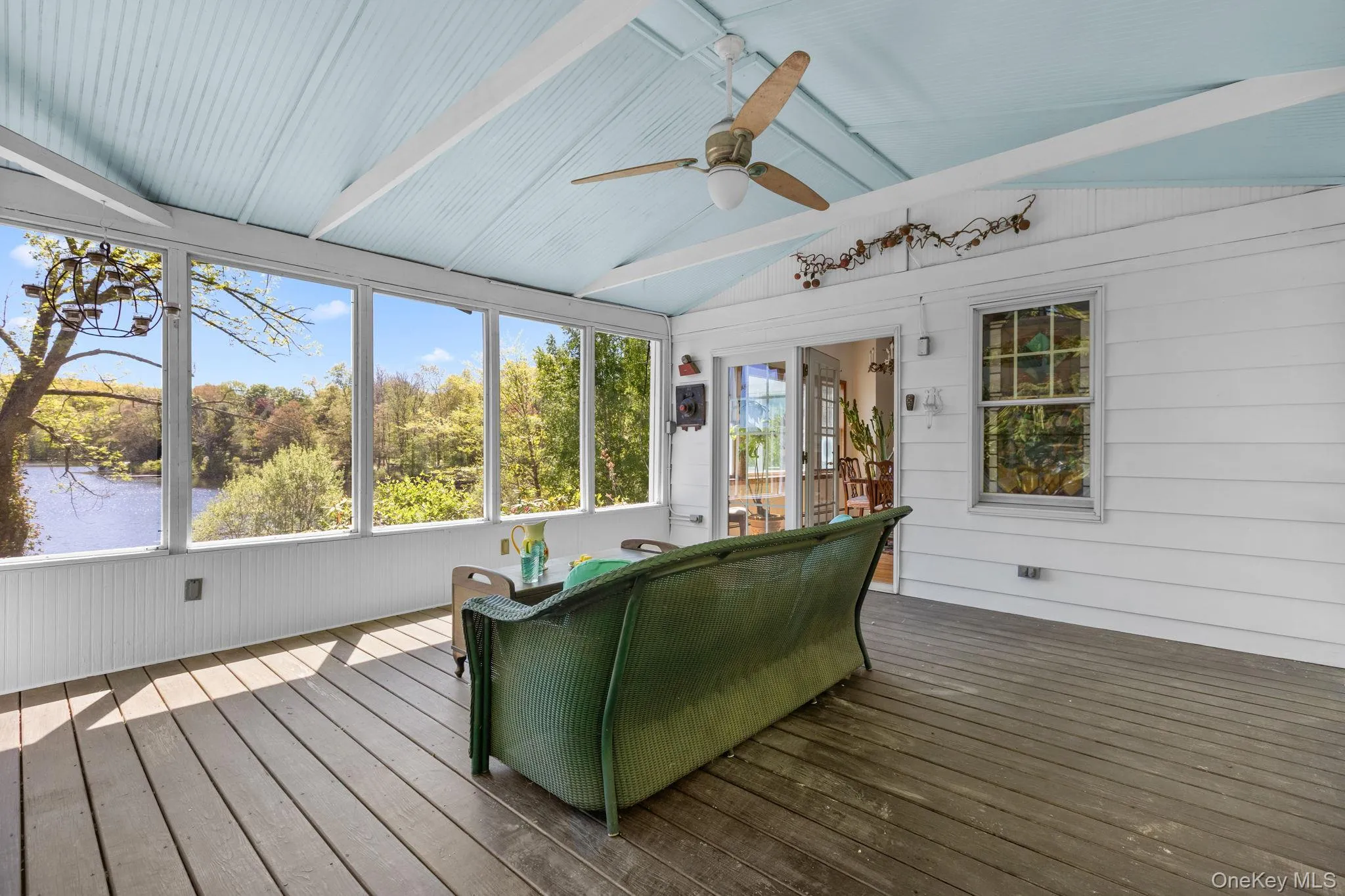 Screened in porch with high wood accented ceiling provides a tranquil spot for your morning coffee or evening meal Screened in porch with high wood accented ceiling provides a tranquil spot for your morning coffee or evening meal