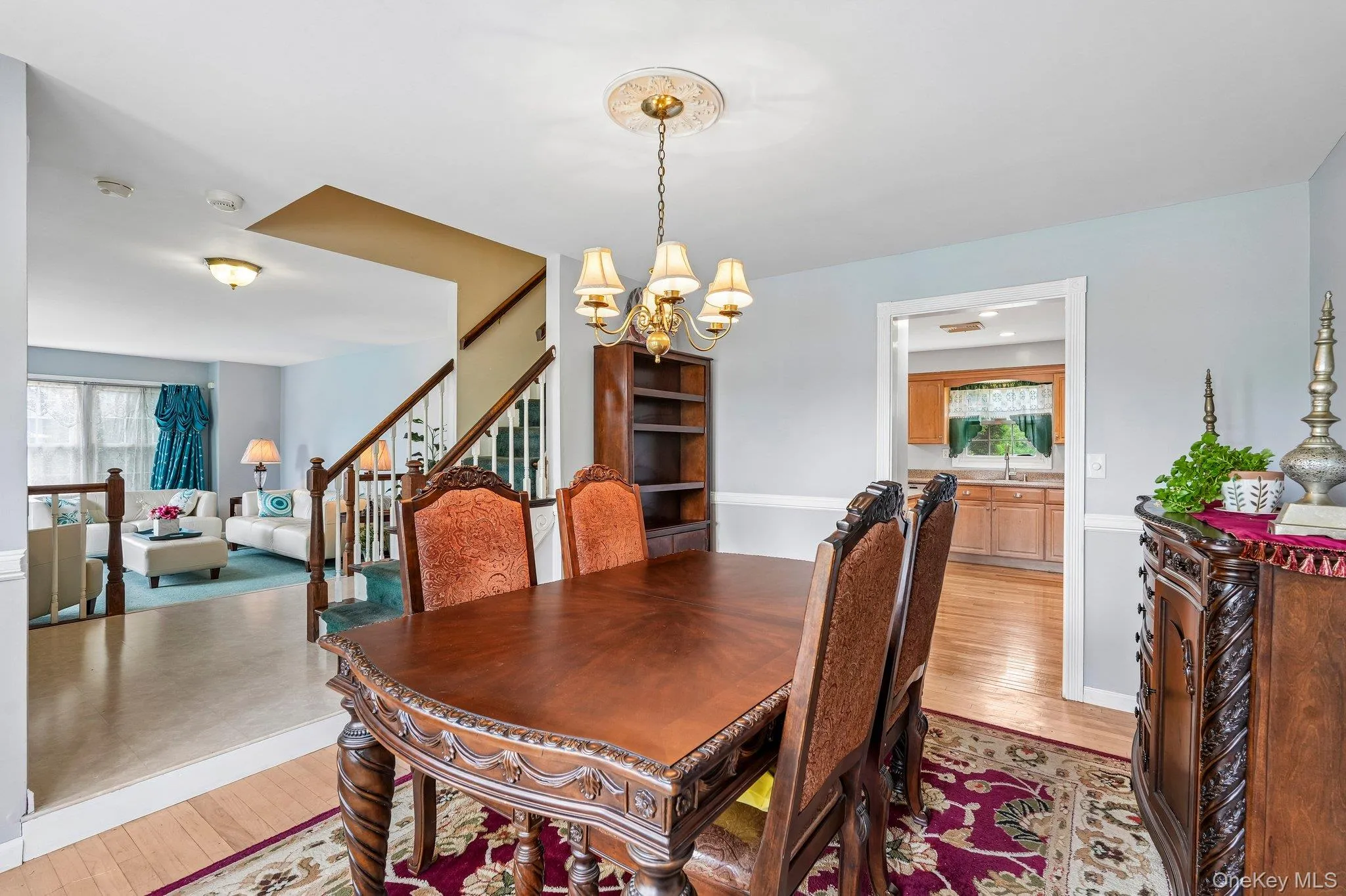 Spacious formal dining room featuring a large bay window that fills the space with natural light, creating an inviting setting for gatherings and entertaining. Spacious formal dining room featuring a large bay window that fills the space with natural light, creating an inviting setting for gatherings and entertaining.