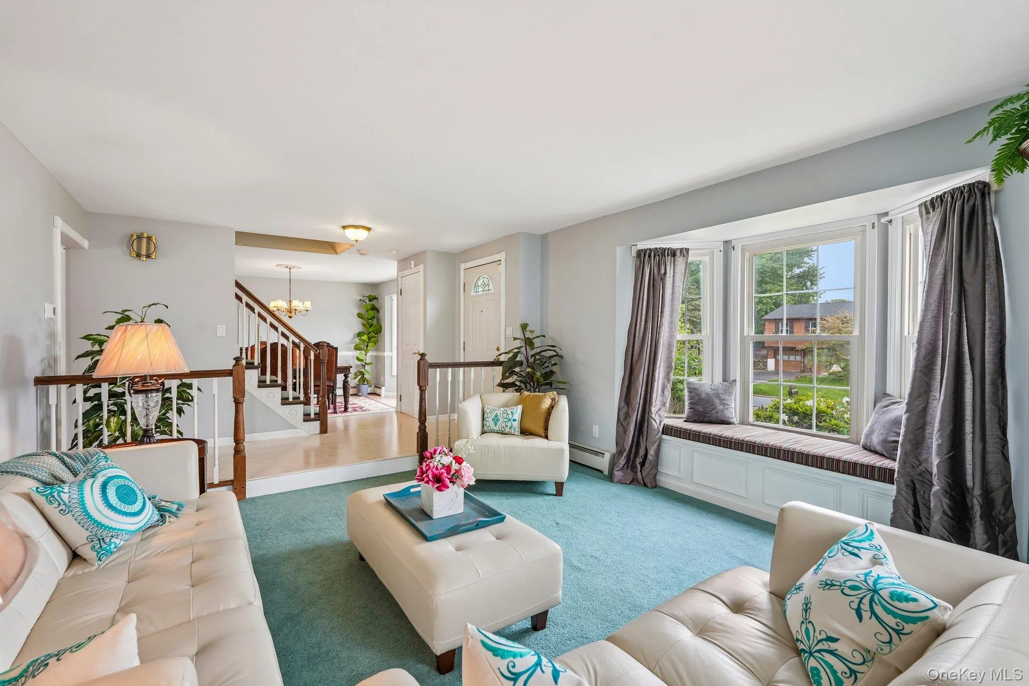 Spacious sunken formal living room featuring large windows, abundant natural light, and an inviting layout for relaxing or entertaining. Spacious sunken formal living room featuring large windows, abundant natural light, and an inviting layout for relaxing or entertaining.