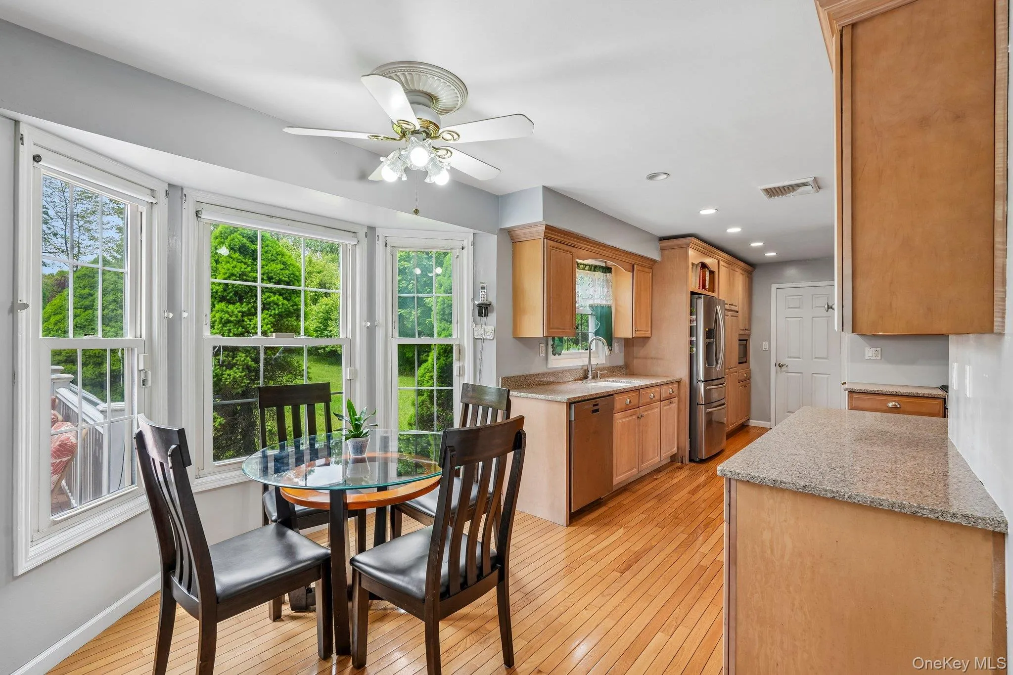 Cozy eat-in kitchenette with a small dining area surrounded by large windows, creating a bright and inviting space for casual meals. Cozy eat-in kitchenette with a small dining area surrounded by large windows, creating a bright and inviting space for casual meals.