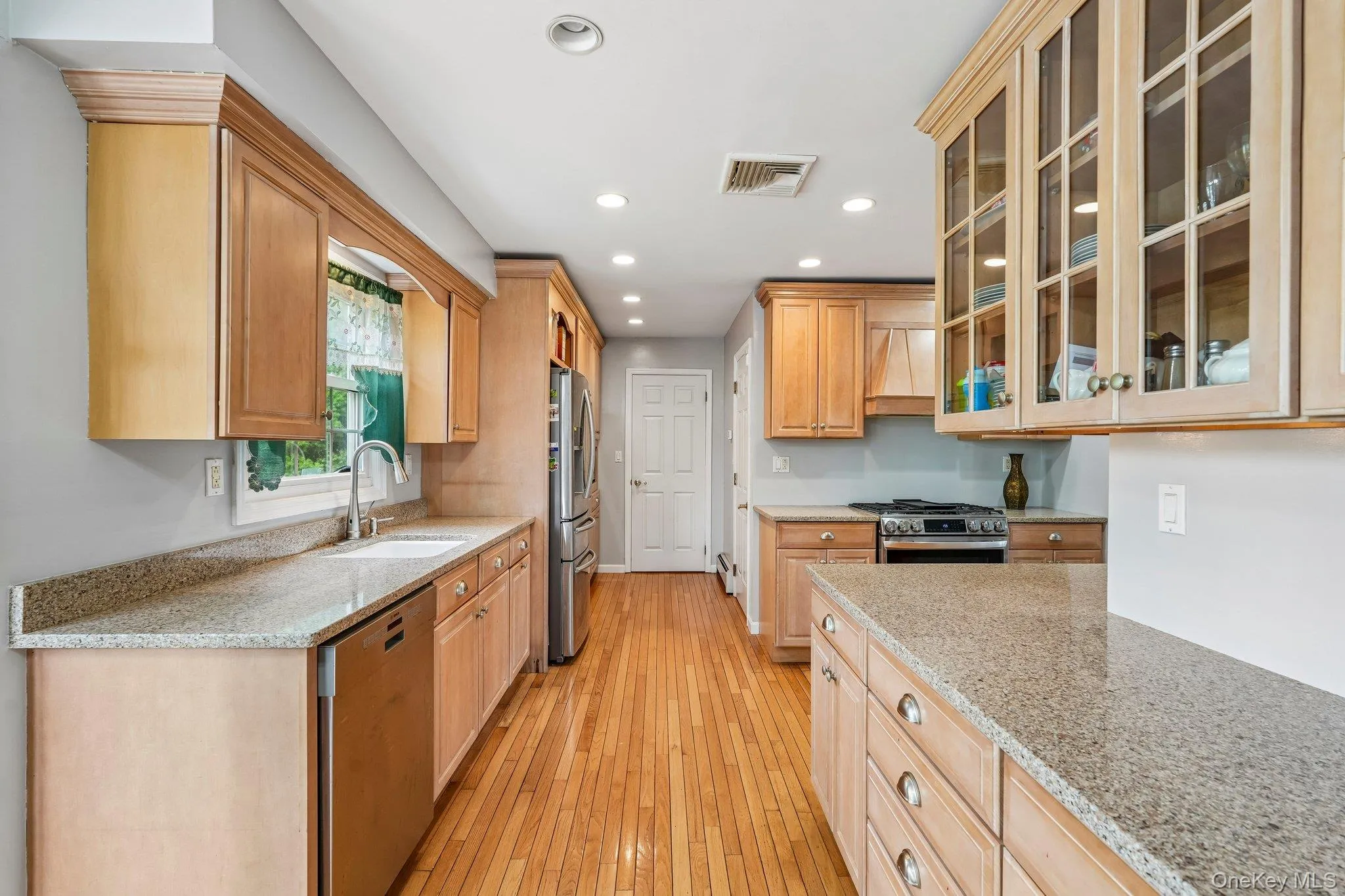 Bright kitchen with recessed lighting, hardwood floors, and seamless flow to the surrounding living areas. Bright kitchen with recessed lighting, hardwood floors, and seamless flow to the surrounding living areas.