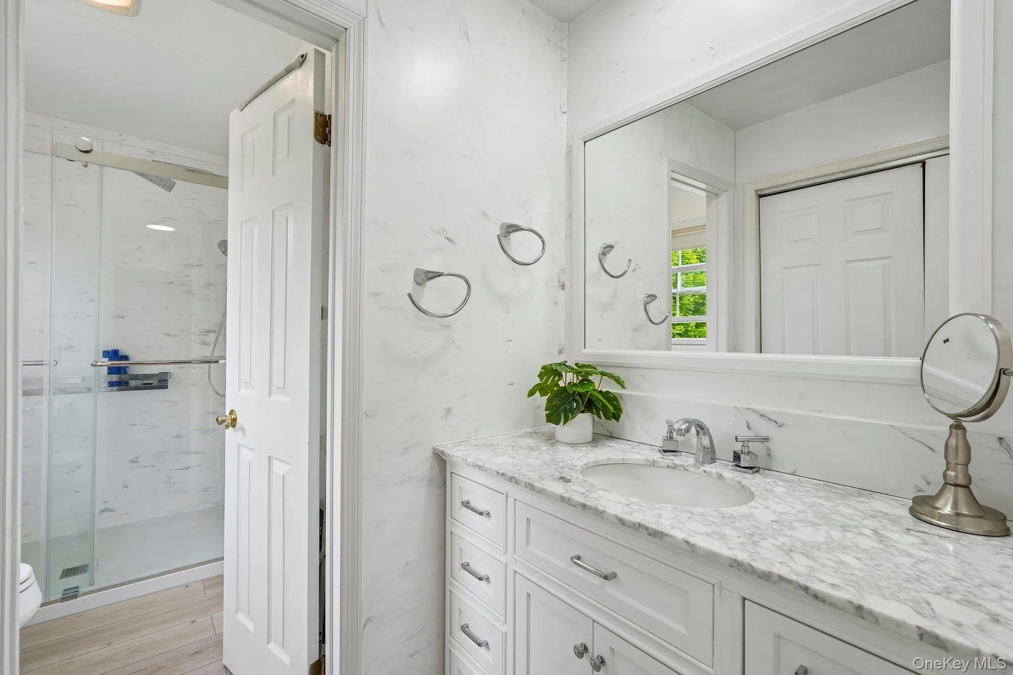 Spacious primary bathroom with an oversized vanity, ample storage, and a clean, modern design. Spacious primary bathroom with an oversized vanity, ample storage, and a clean, modern design.