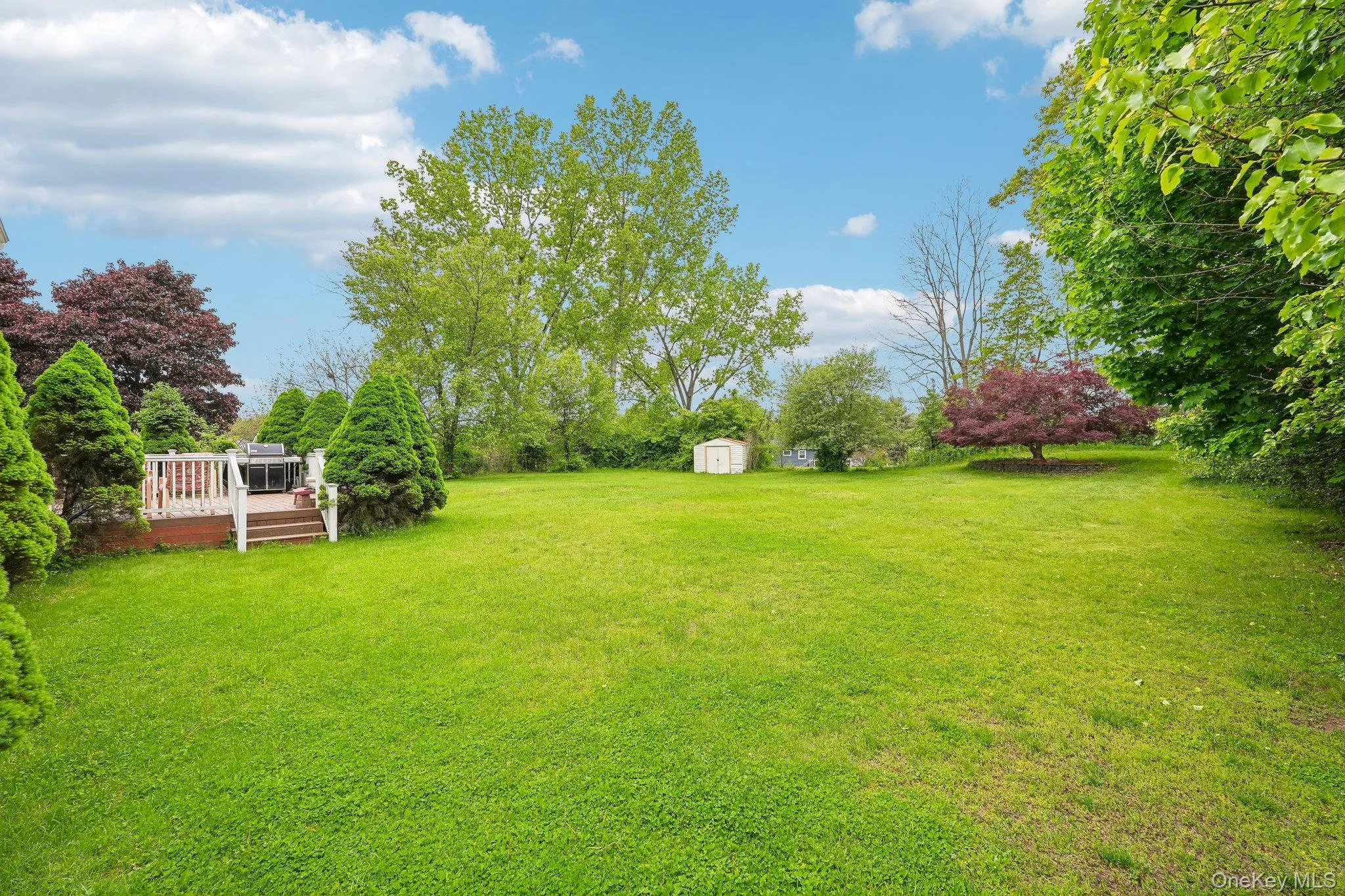 Spacious level backyard offering a peaceful setting surrounded by mature landscaping. Spacious level backyard offering a peaceful setting surrounded by mature landscaping.