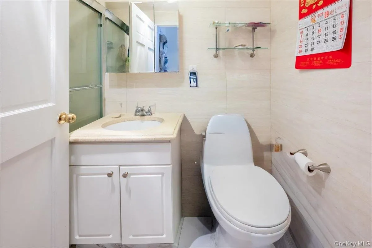 Full bath with vanity and tile walls Full bath with vanity and tile walls