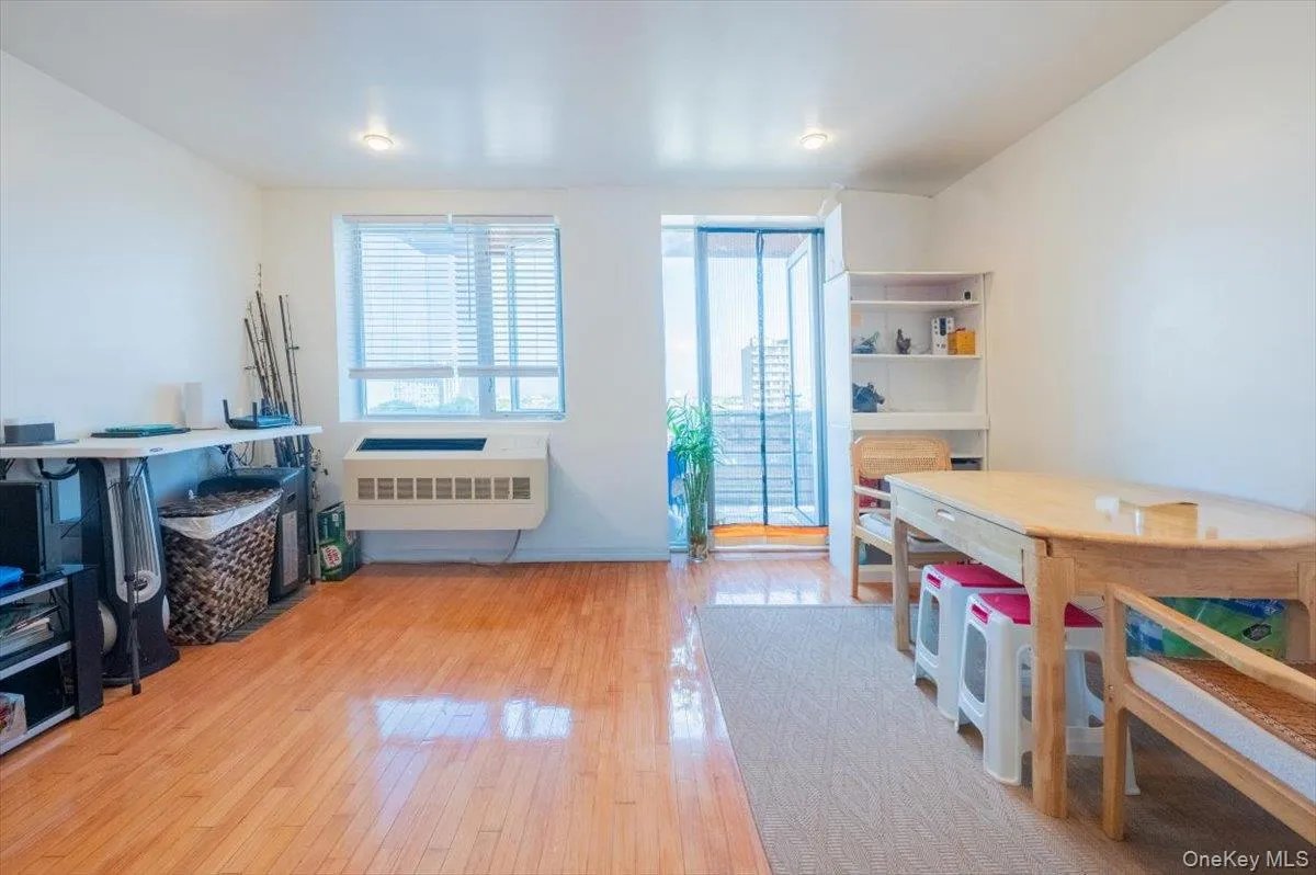 Rec room featuring radiator heating unit and light wood finished floors Rec room featuring radiator heating unit and light wood finished floors