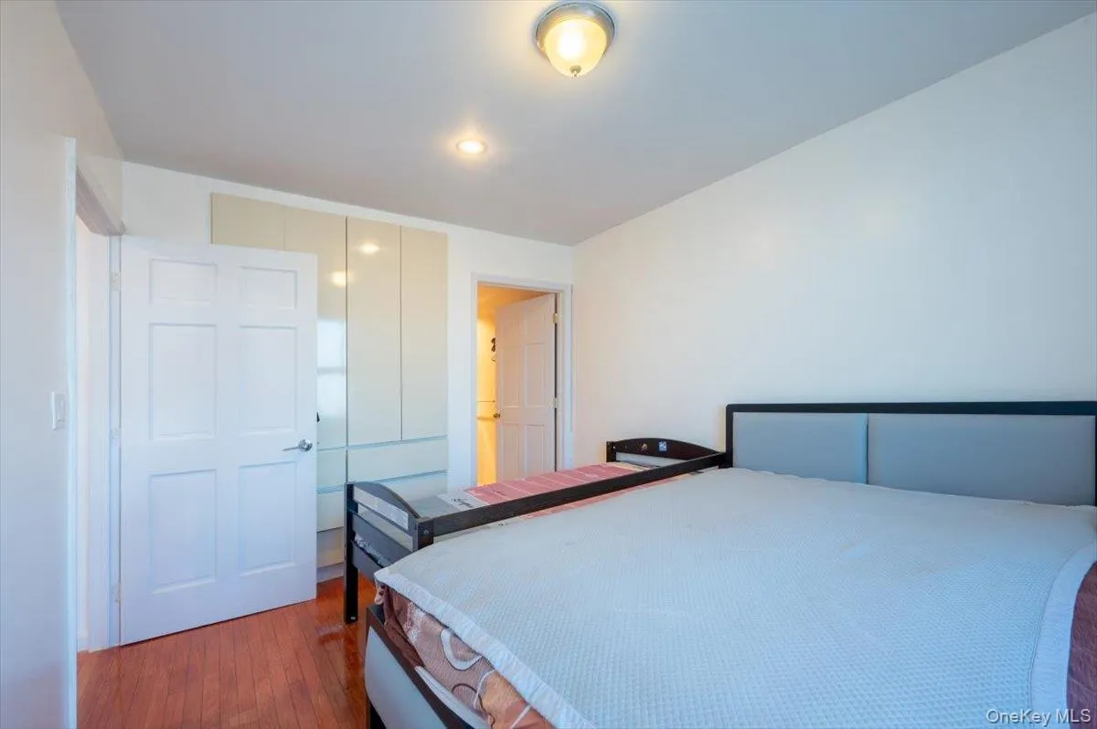 Bedroom with wood finished floors and a closet Bedroom with wood finished floors and a closet