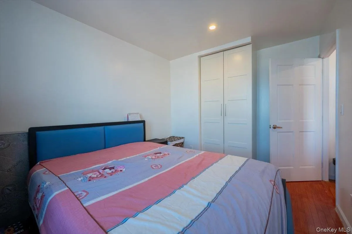 Bedroom featuring a closet, wood finished floors, and recessed lighting Bedroom featuring a closet, wood finished floors, and recessed lighting