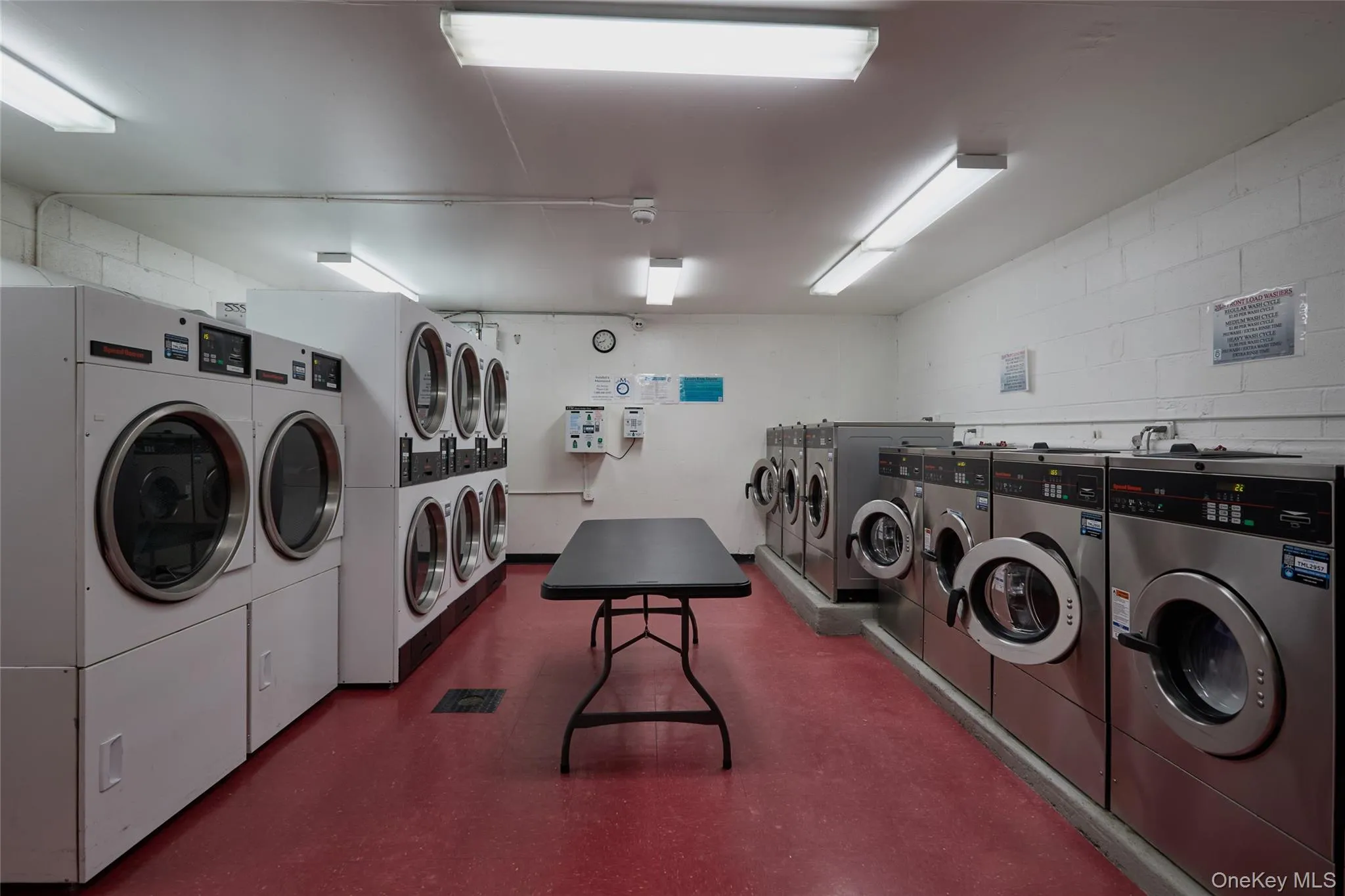 Laundry room with many washers and dryers Laundry room with many washers and dryers