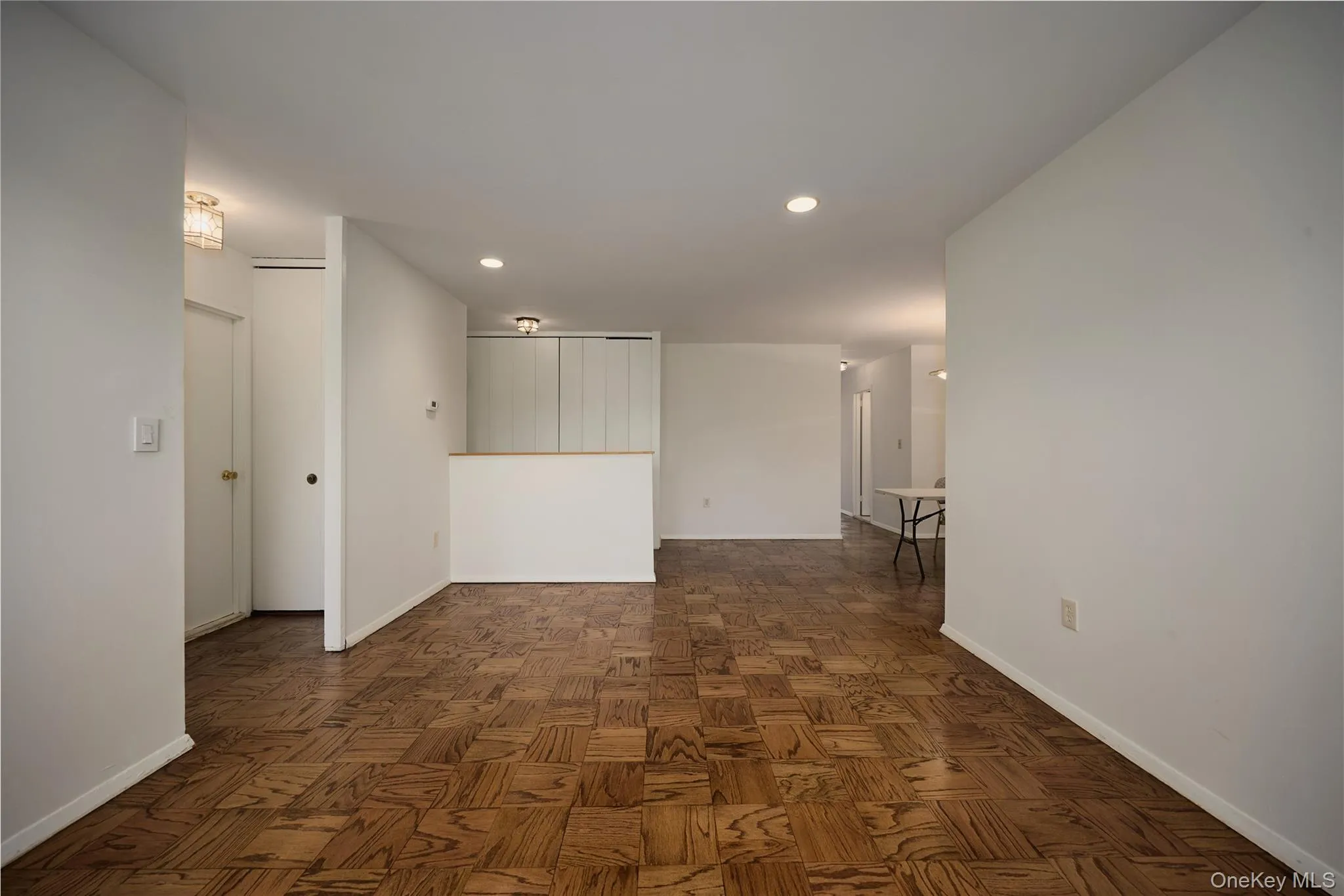 Living Room looking towards entrance to primary bedroom on the left as well as the entrance hall to 2nd bedroom and bathroom to the right Living Room looking towards entrance to primary bedroom on the left as well as the entrance hall to 2nd bedroom and bathroom to the right