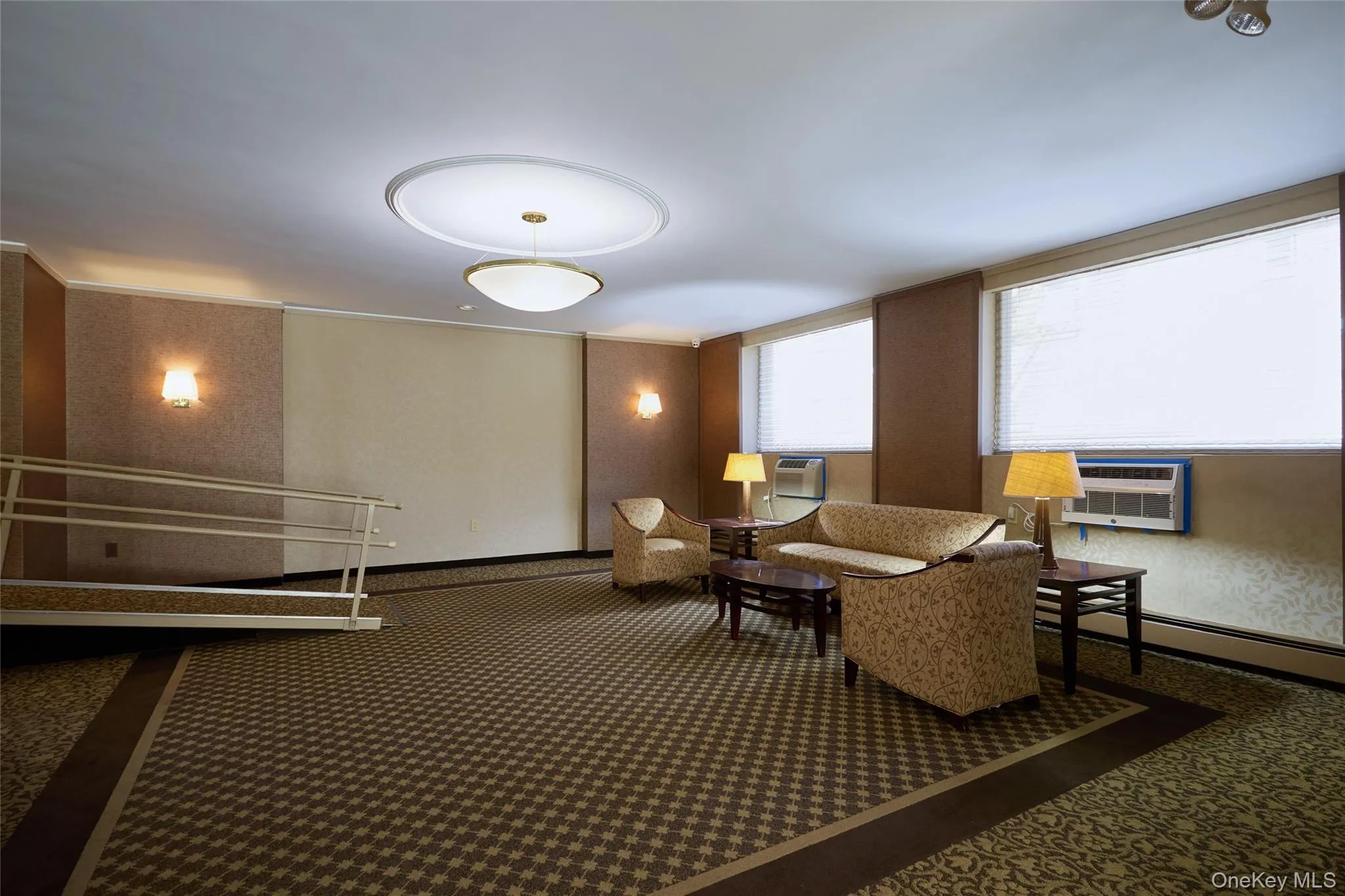 Carpeted common area with a permanent ramp Carpeted common area with a permanent ramp