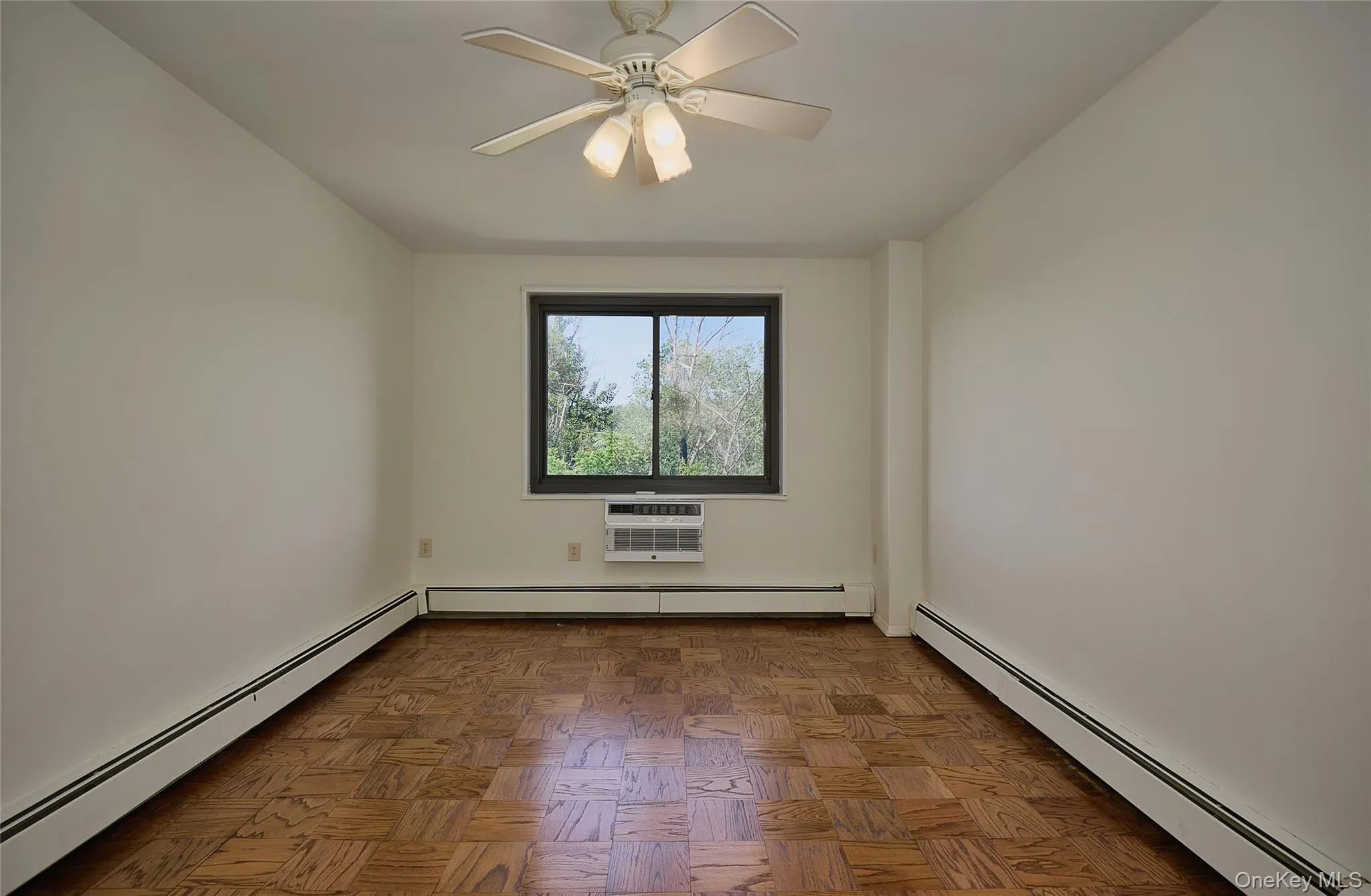 Spacious Primary Bedroom with parquet floors and view of the golf course Spacious Primary Bedroom with parquet floors and view of the golf course