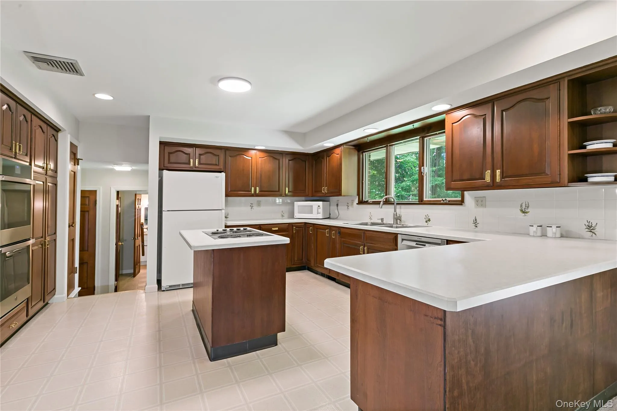 Another angle of the kitchen showing breakfast counter. Another angle of the kitchen showing breakfast counter.