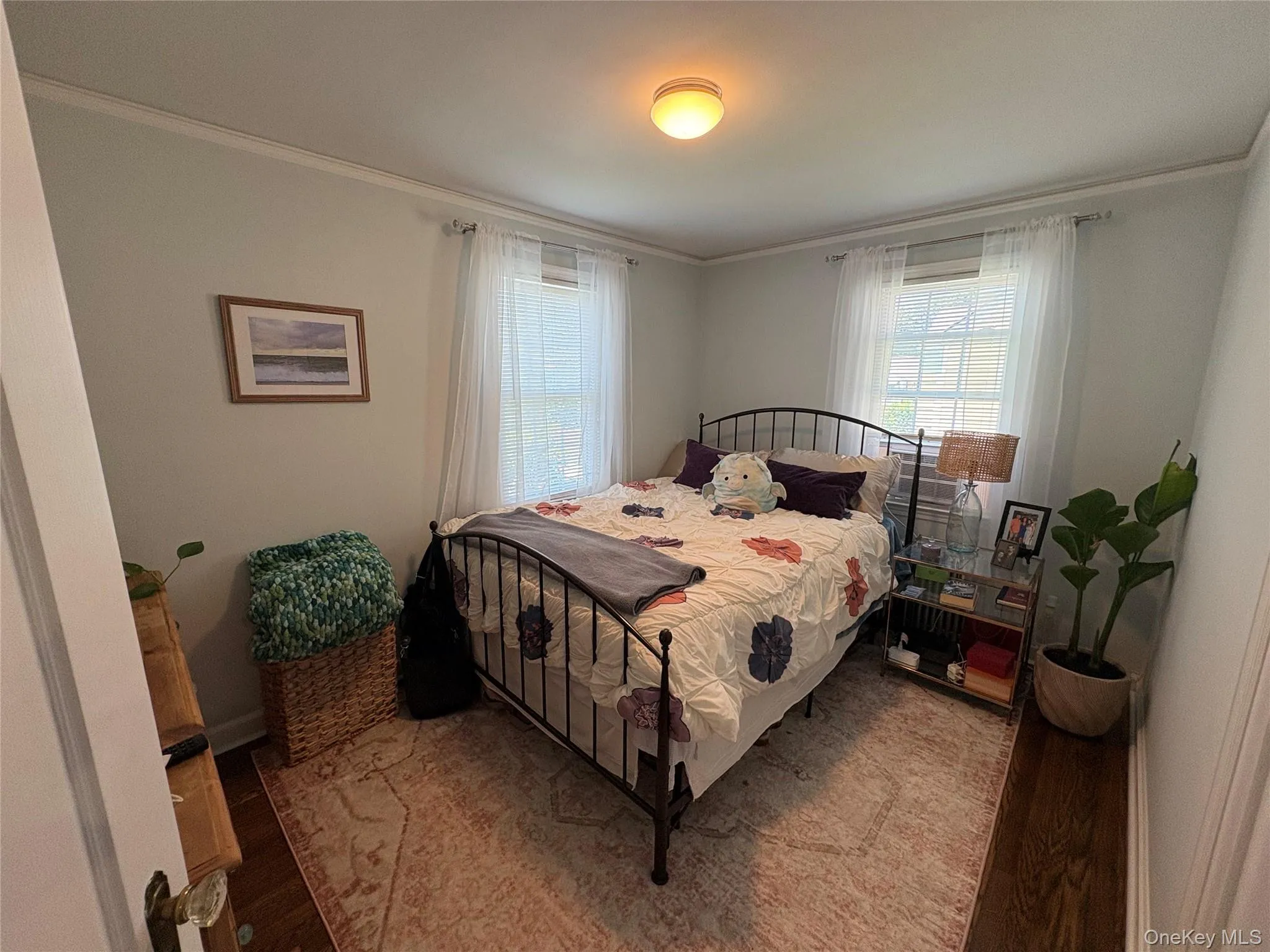 1st Floor Bedroom featuring wood finished floors, ornamental molding, and multiple windows 1st Floor Bedroom featuring wood finished floors, ornamental molding, and multiple windows