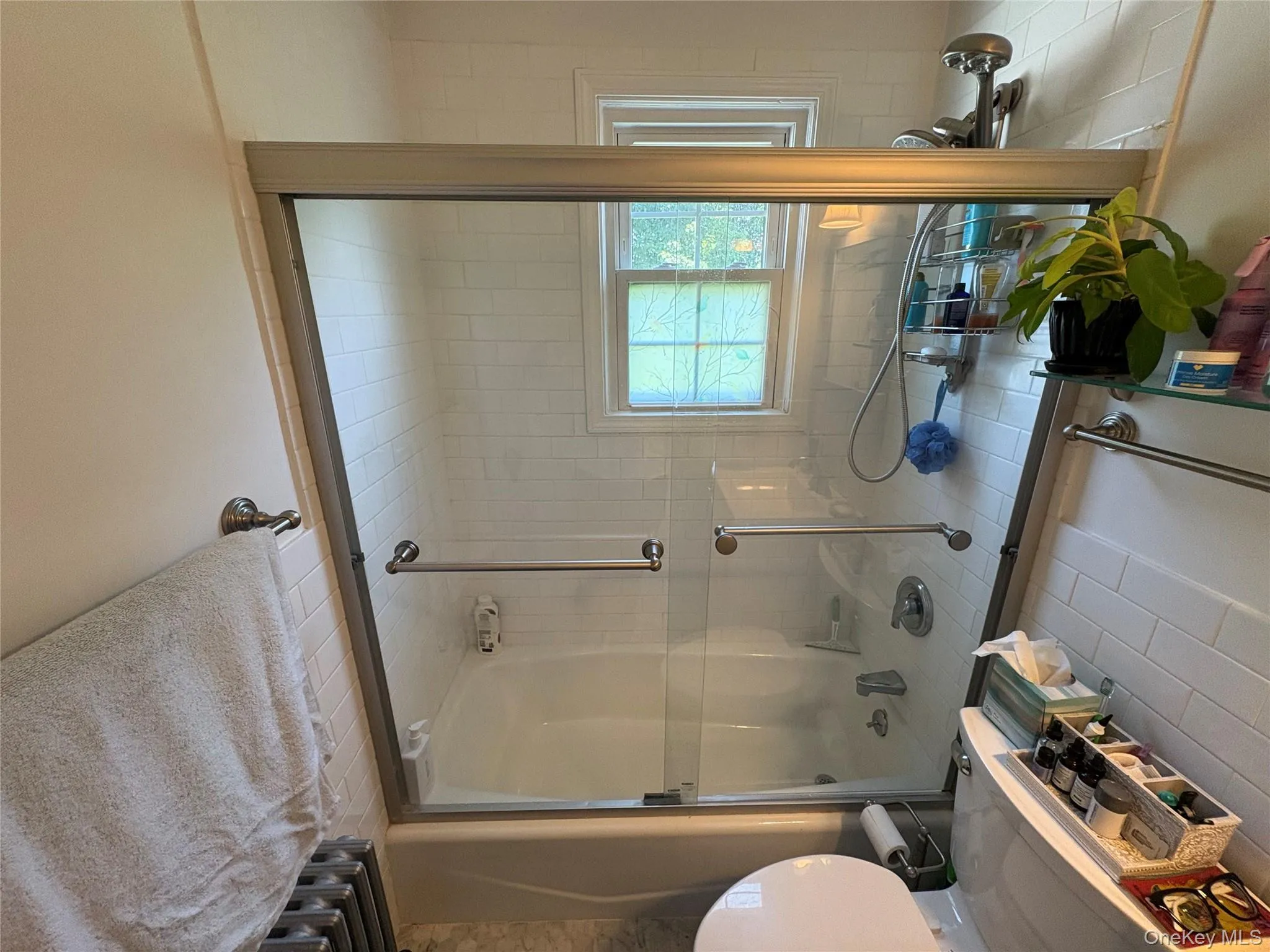 Full bath featuring enclosed tub / shower combo and toilet Full bath featuring enclosed tub / shower combo and toilet