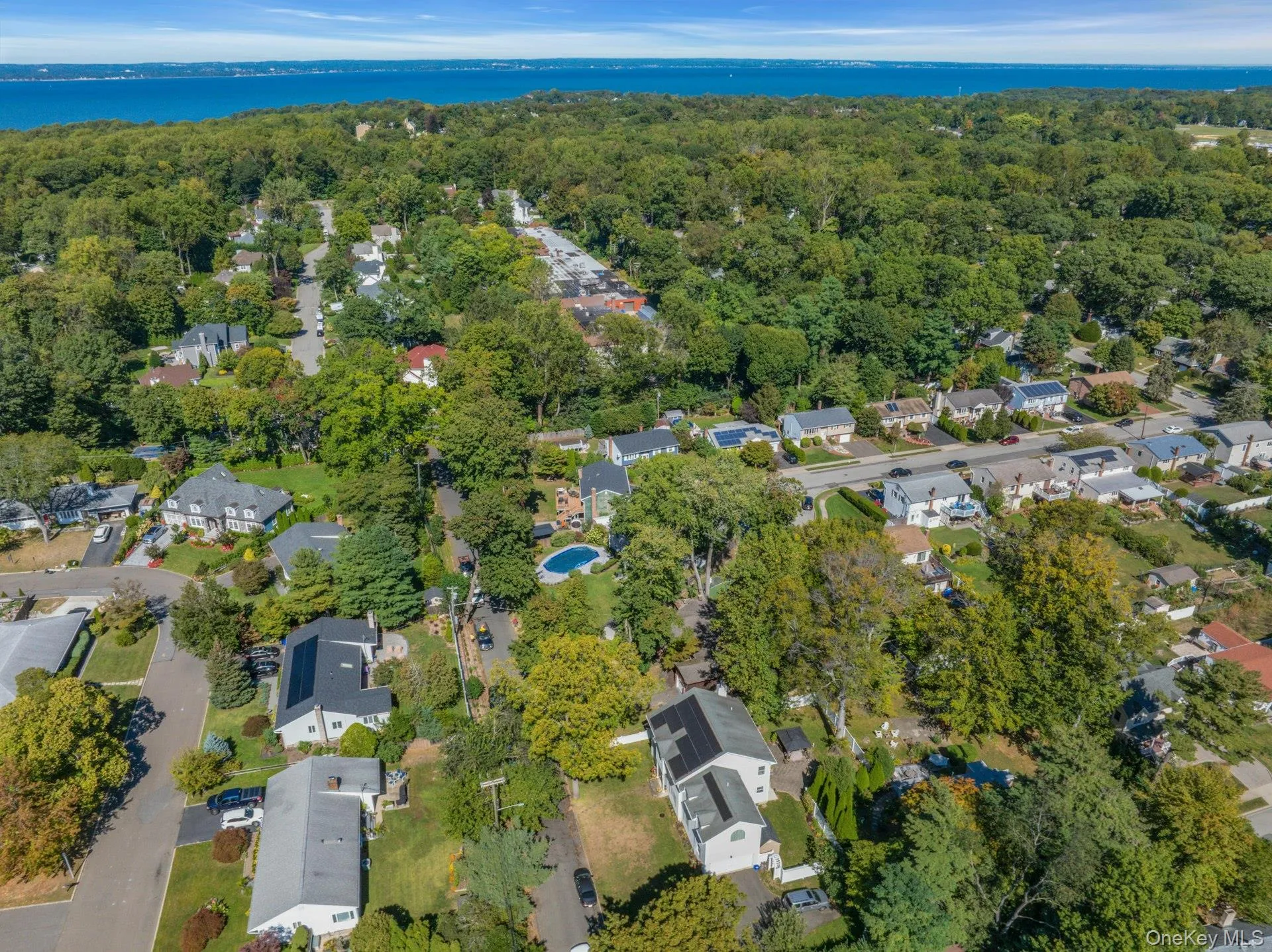 Aerial overview of property's location featuring nearby suburban area and a large body of water Aerial overview of property's location featuring nearby suburban area and a large body of water
