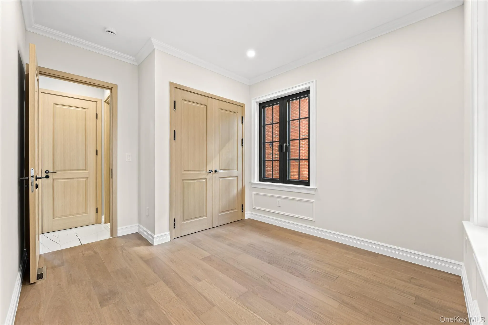 Entryway with crown molding, light wood-style flooring, and recessed lighting Entryway with crown molding, light wood-style flooring, and recessed lighting