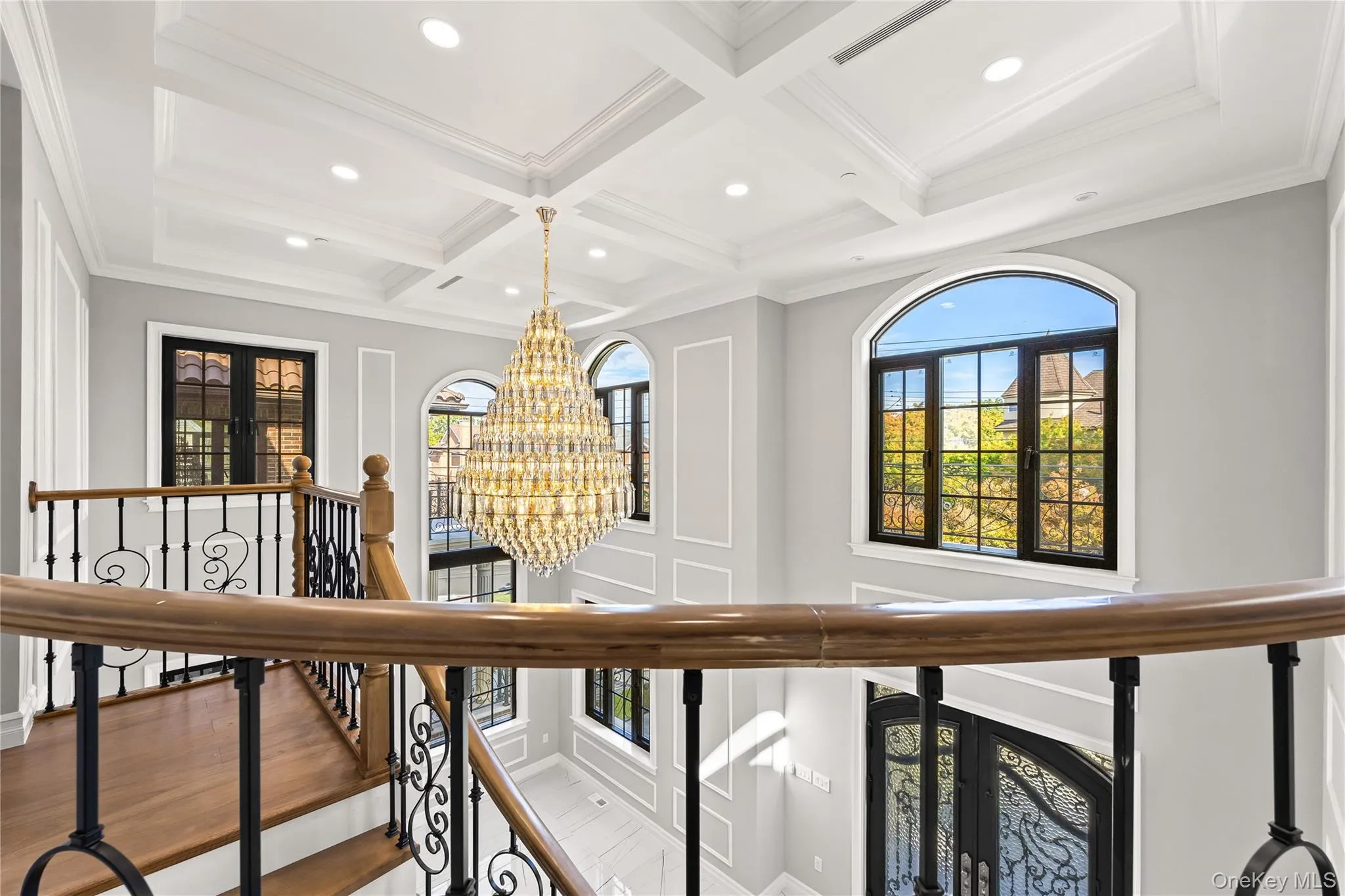 Hallway featuring a chandelier, beam ceiling, coffered ceiling, wood finished floors, and recessed lighting Hallway featuring a chandelier, beam ceiling, coffered ceiling, wood finished floors, and recessed lighting