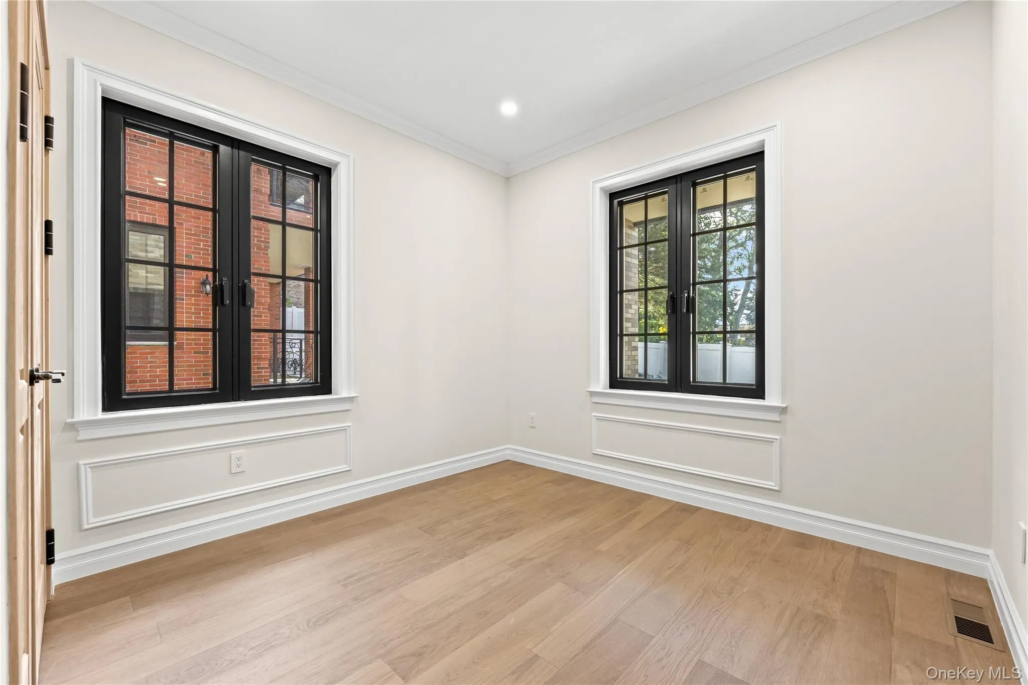 Empty room with ornamental molding, light wood-style flooring, and recessed lighting Empty room with ornamental molding, light wood-style flooring, and recessed lighting