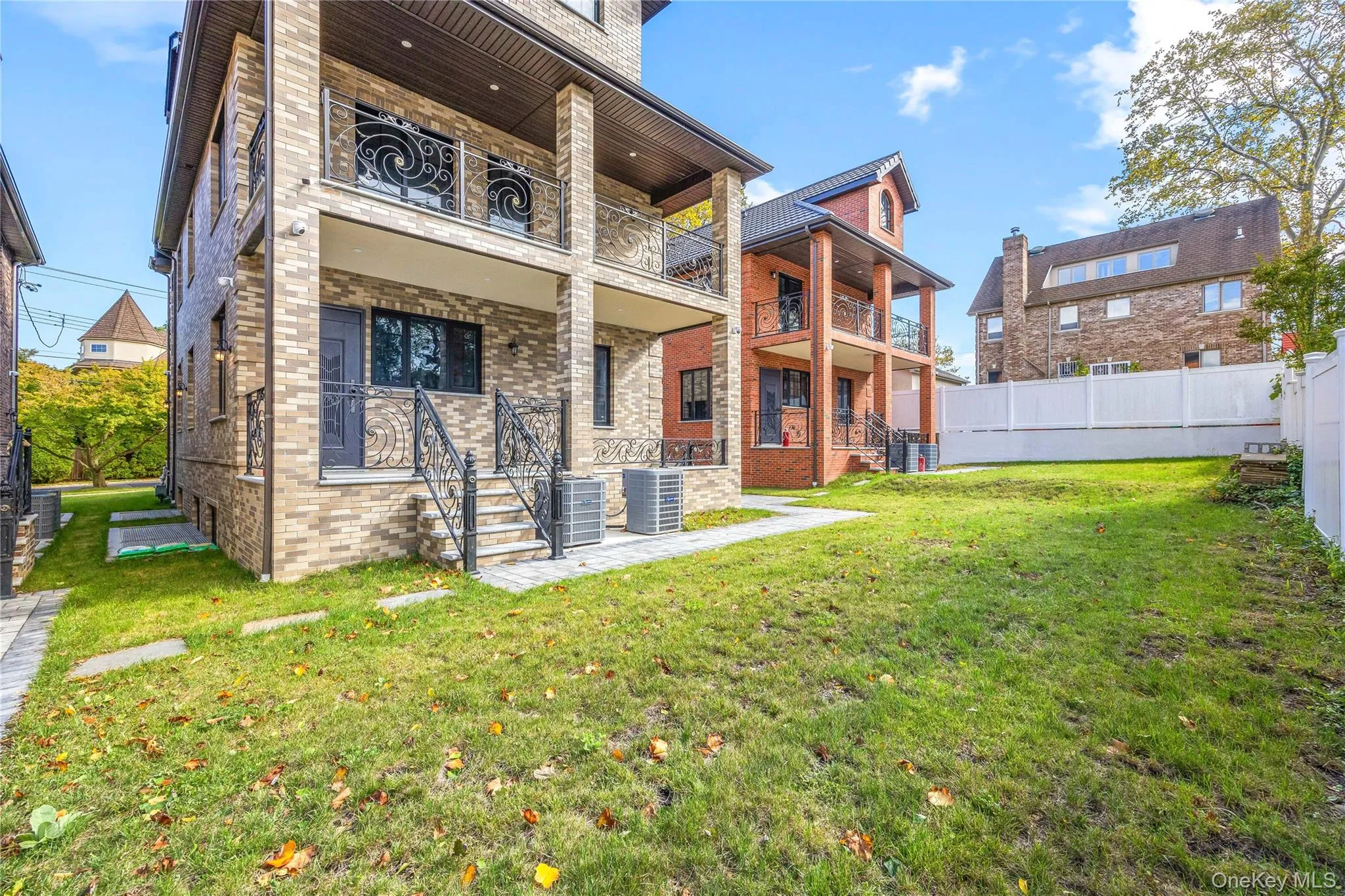 Back of property with brick siding and a balcony Back of property with brick siding and a balcony