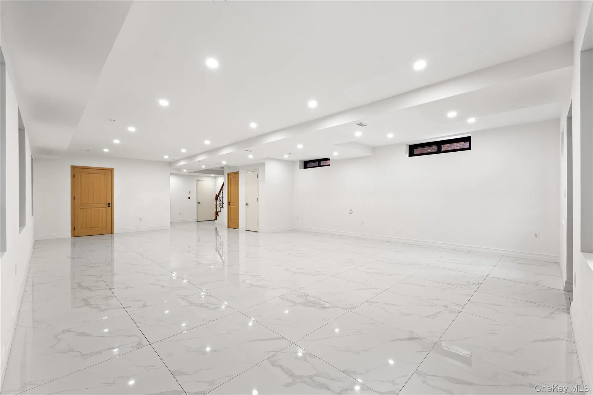 Spare room with light marble finish flooring and recessed lighting Spare room with light marble finish flooring and recessed lighting