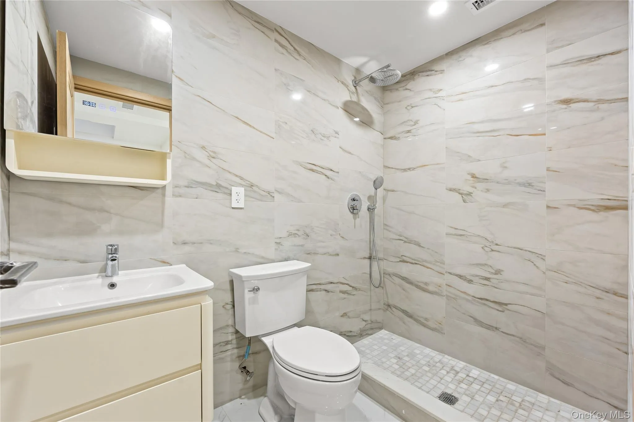 Full bath featuring tile walls, vanity, and a marble finish shower Full bath featuring tile walls, vanity, and a marble finish shower